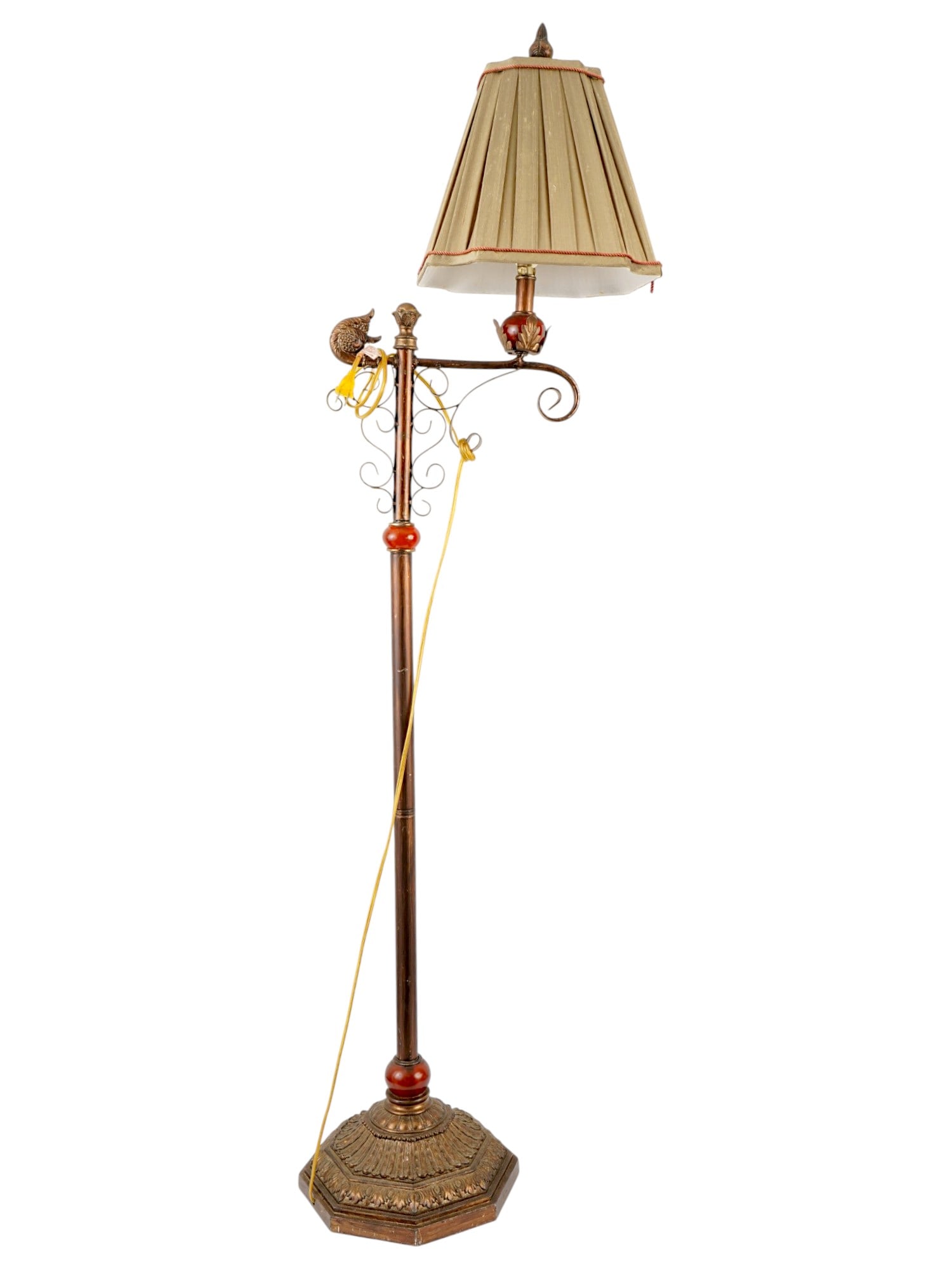 VINTAGE BRIDGE FLOOR LAMP WITH A PLEATED LINEN SHADE: A vintage bridge floor lamp featuring a copper-finished stand with burgundy glass accents and ornate cast detailing. The classic bridge-arm design supports a single light source, complemented by a ple