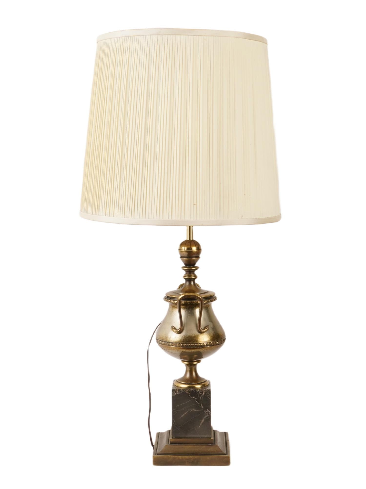 ANTIQUE URN SHAPED BRASS LAMP WITH MARBLE STAND: An antique brass lamp. The body of the lamp has an urn shape. A shade is decorated with a draped probably satin fabric. Mounted on a marble stand. Circa: late 19th century to early 20th century. Antiq