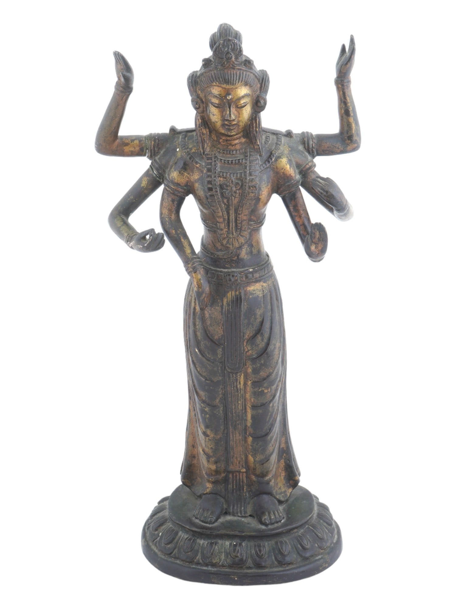 KOREAN GILT BRONZE SIX ARMED SHIVA DEITY SCULPTURE: An antique gilt bronze six armed Shiva Deity sculpture. The figure is depicted standing with six hands folded in a variety of mudra gestures. The figure stands on a pedestal with a relief pattern arou