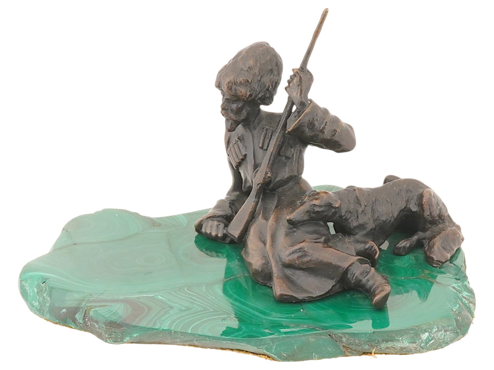 ANTIQUE RUSSIAN BRONZE COSSACK WITH A DOG SCULPTURE: An antique Russian School bronze sculpture depicting a Cossack with a rifle and a dog at rest, presented on a malachite stand. Dating to the late 19th century or early 20th century. Antique Russian Br
