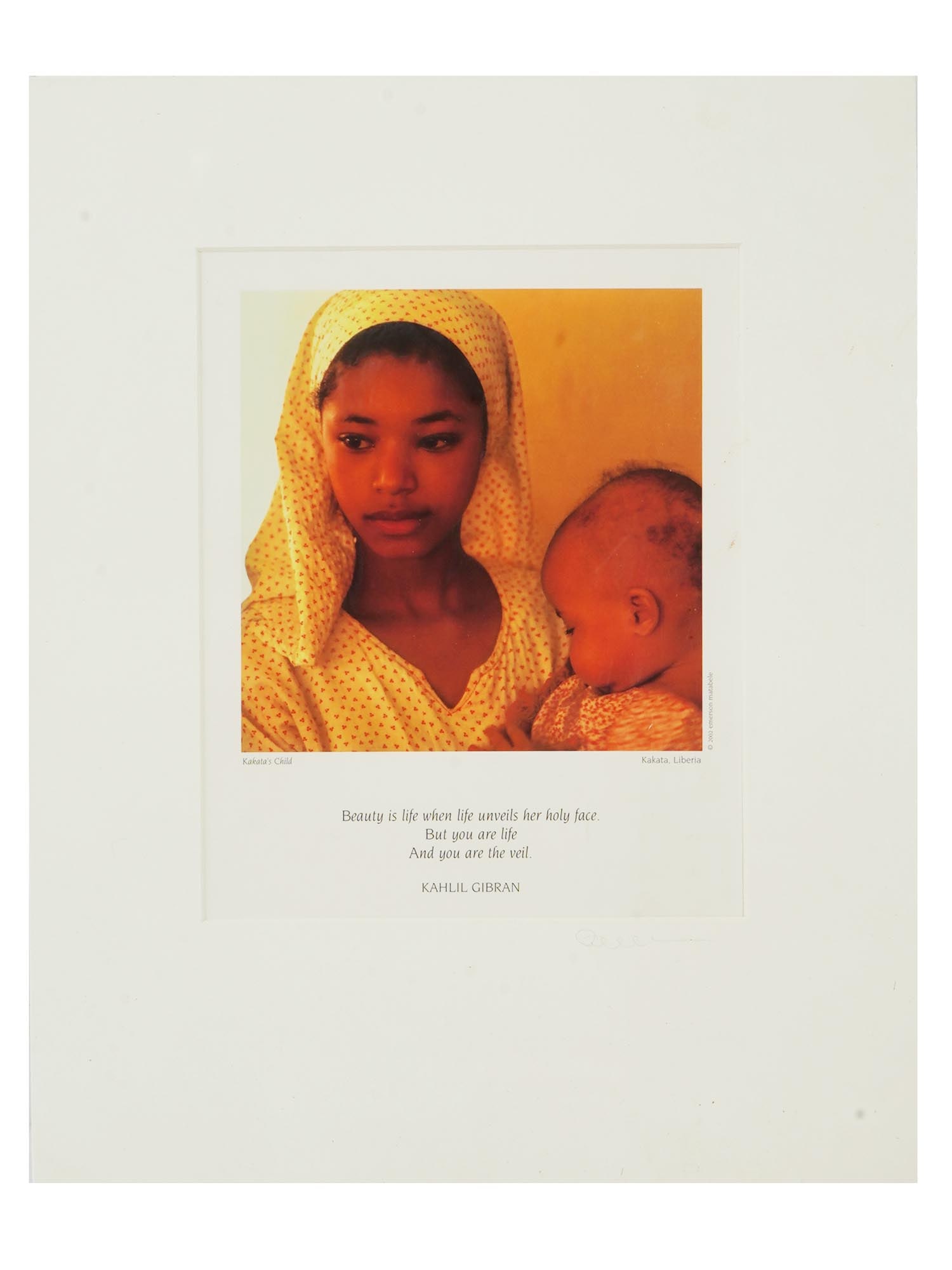AMERICAN PRINT KAKATAS CHILD BY EMERSON MATABELE: Emerson Matabele, American, born 1953, color lithographic print reproduced from a photograph titled Kakatas Child, taken in the 1990s. The artwork features a Liberian woman holding a baby, portraying 