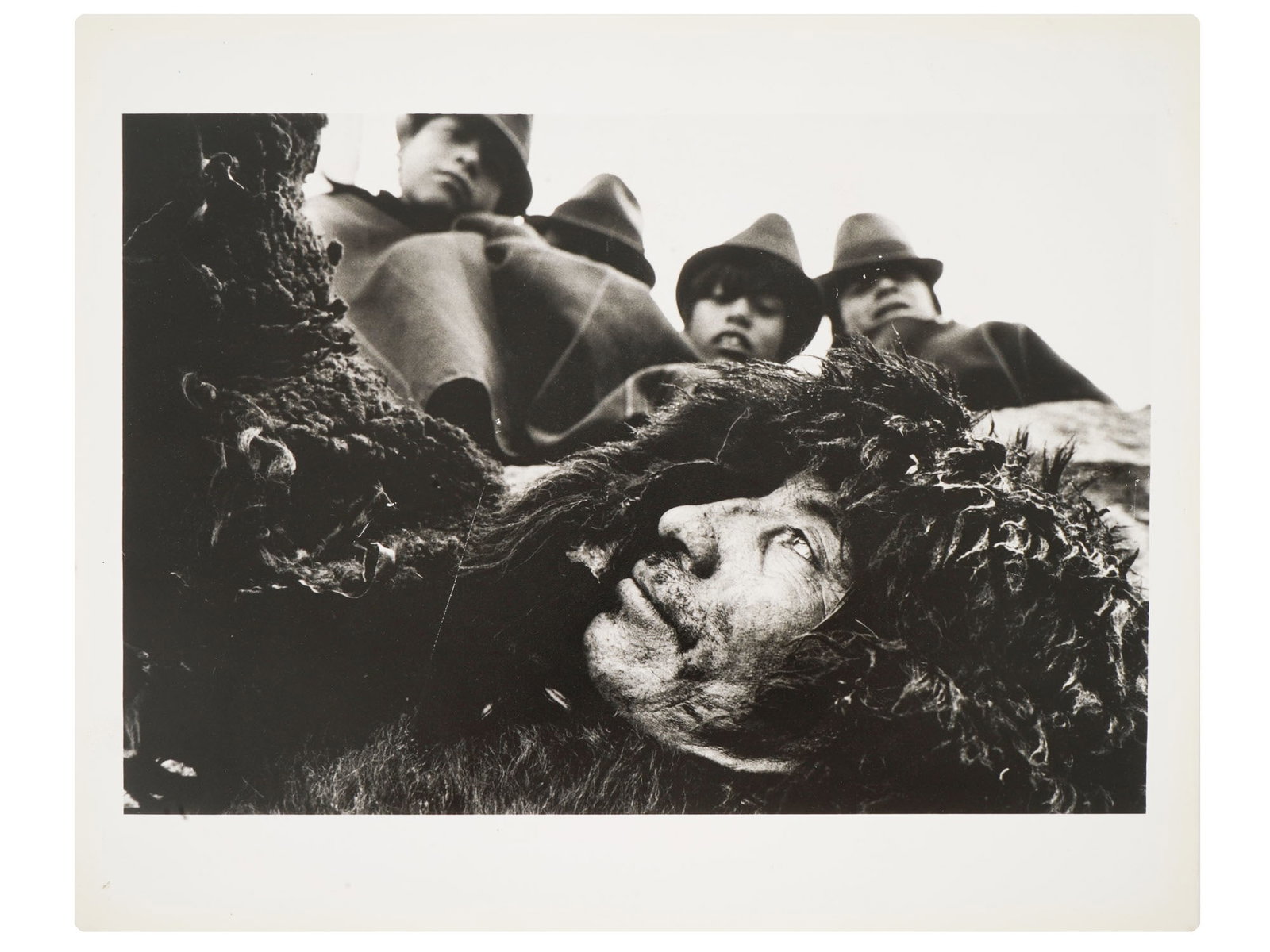 LATIN AMERICAN SOCIAL PHOTO BY SEBASTIAO SALGADO: A black and white photograph, titled In the Very High Areas of Ecuador, People Sometimes Wear Sheepskins to Protect Themselves from the Cold and the Humidity, Atillo, Ecuador. It was captured in 1982 