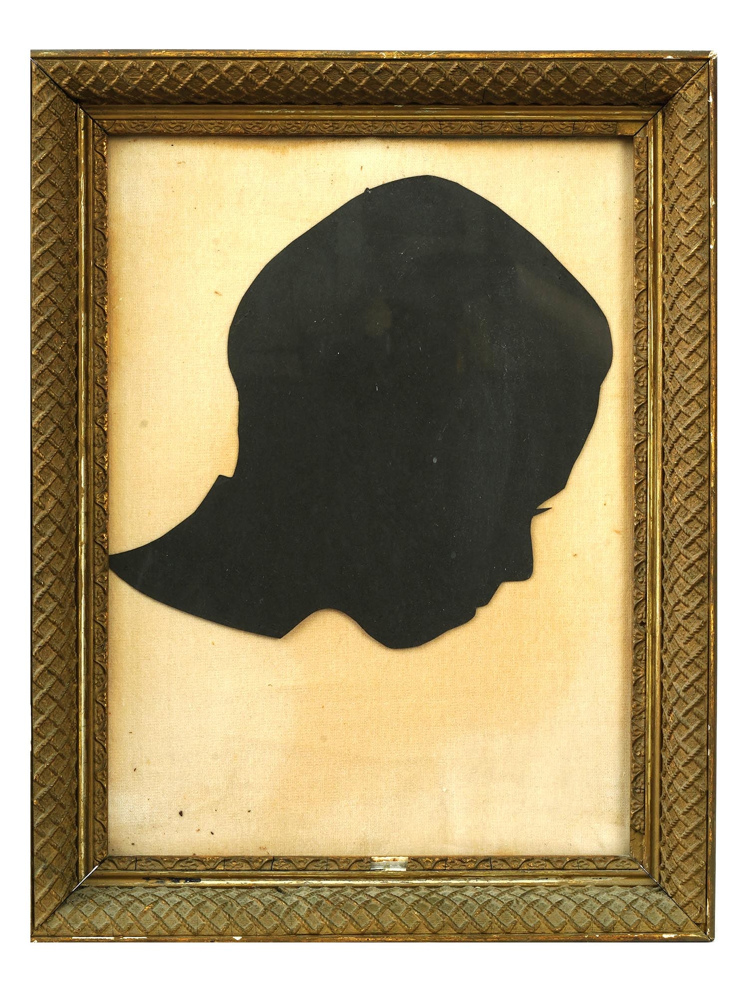 MID CENTURY SILHOUETTE PORTRAIT PAPERCUT ON FABRIC: A vintage silhouette paper cut possibly depicting a portrait of a boy attached to the fabric ground. Circa 1950 to 1960s. Silhouettes became popular in the 18th century as a cheaper alternative to ful