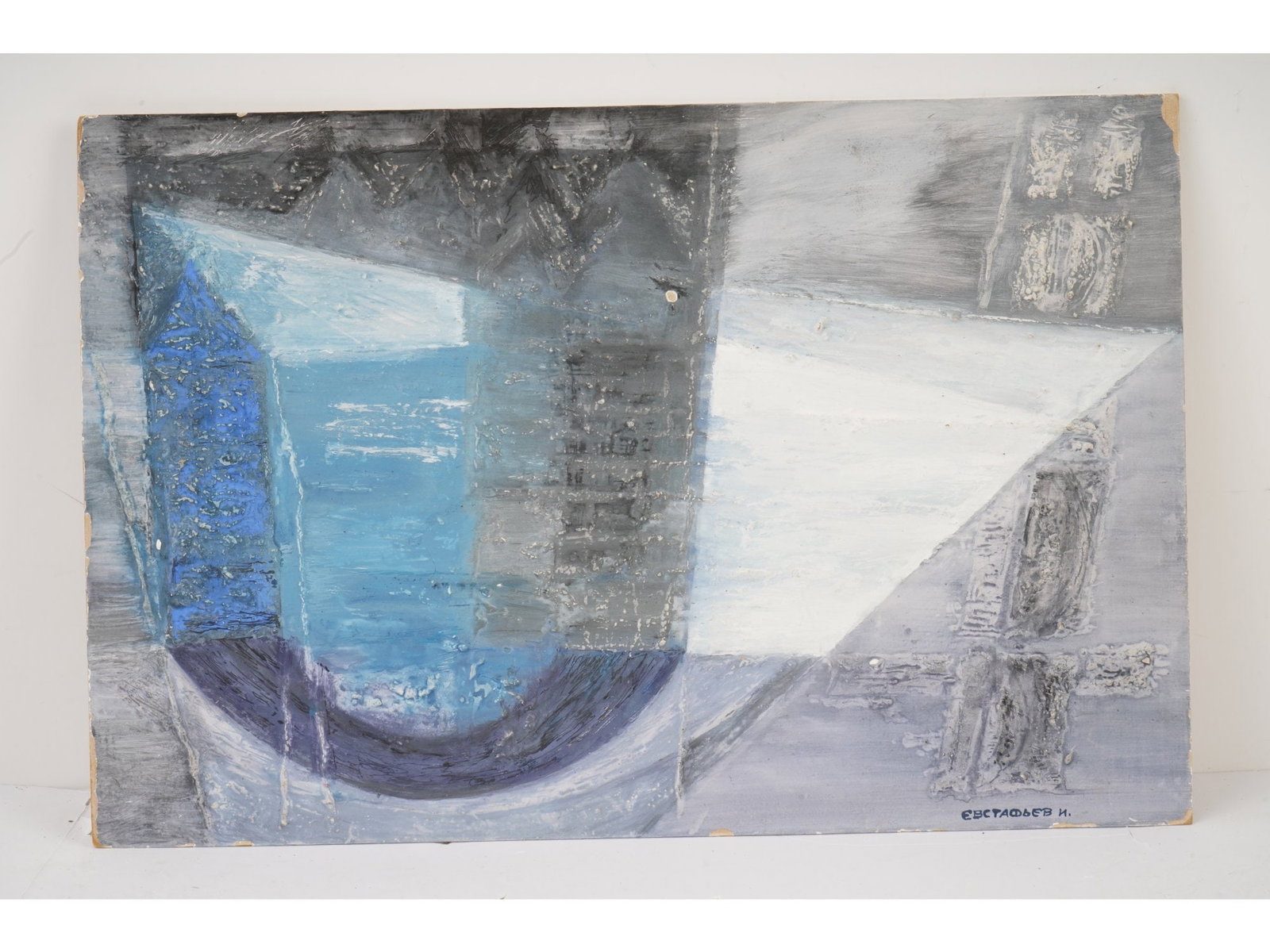 ABSTRACT MIXED MEDIA PAINTING SIGNED N. EVSTAFIEV: Mixed media on board painting. The artwork represents an abstract composition in grey and blue tones, a water reflection of a house facade. The usage of the impasto technique creates a relief surface.
