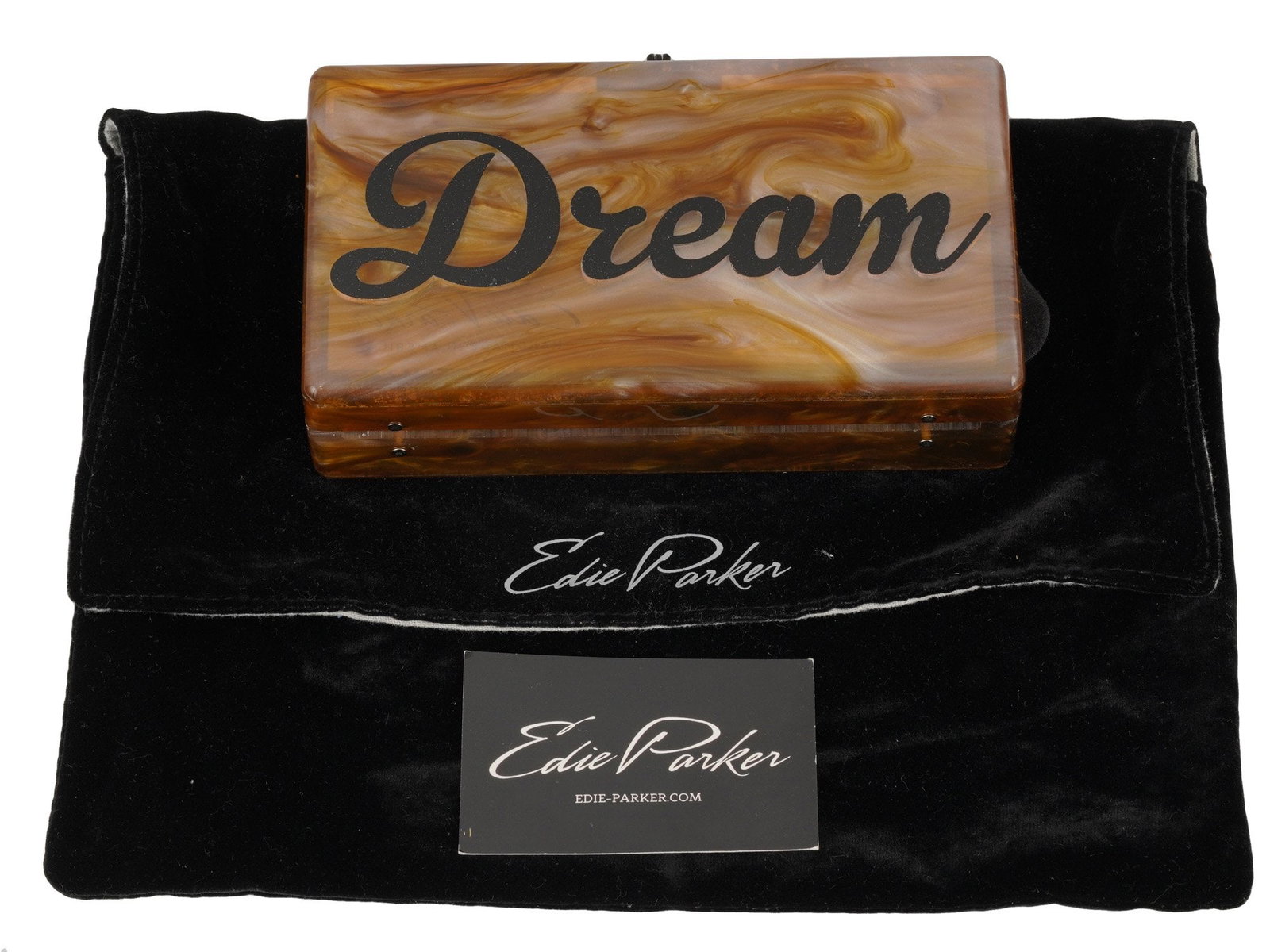 EDIE PARKER SLIM JEAN BOX CLUTCH IN BROWN DREAM: Slim Jean box clutch by Edie Parker. Brown Turtle color with Dream front message in black cursive. Black hardware. The piece comes with a dust bag and brochure. Edie Parker is an NYC-based lifestyle