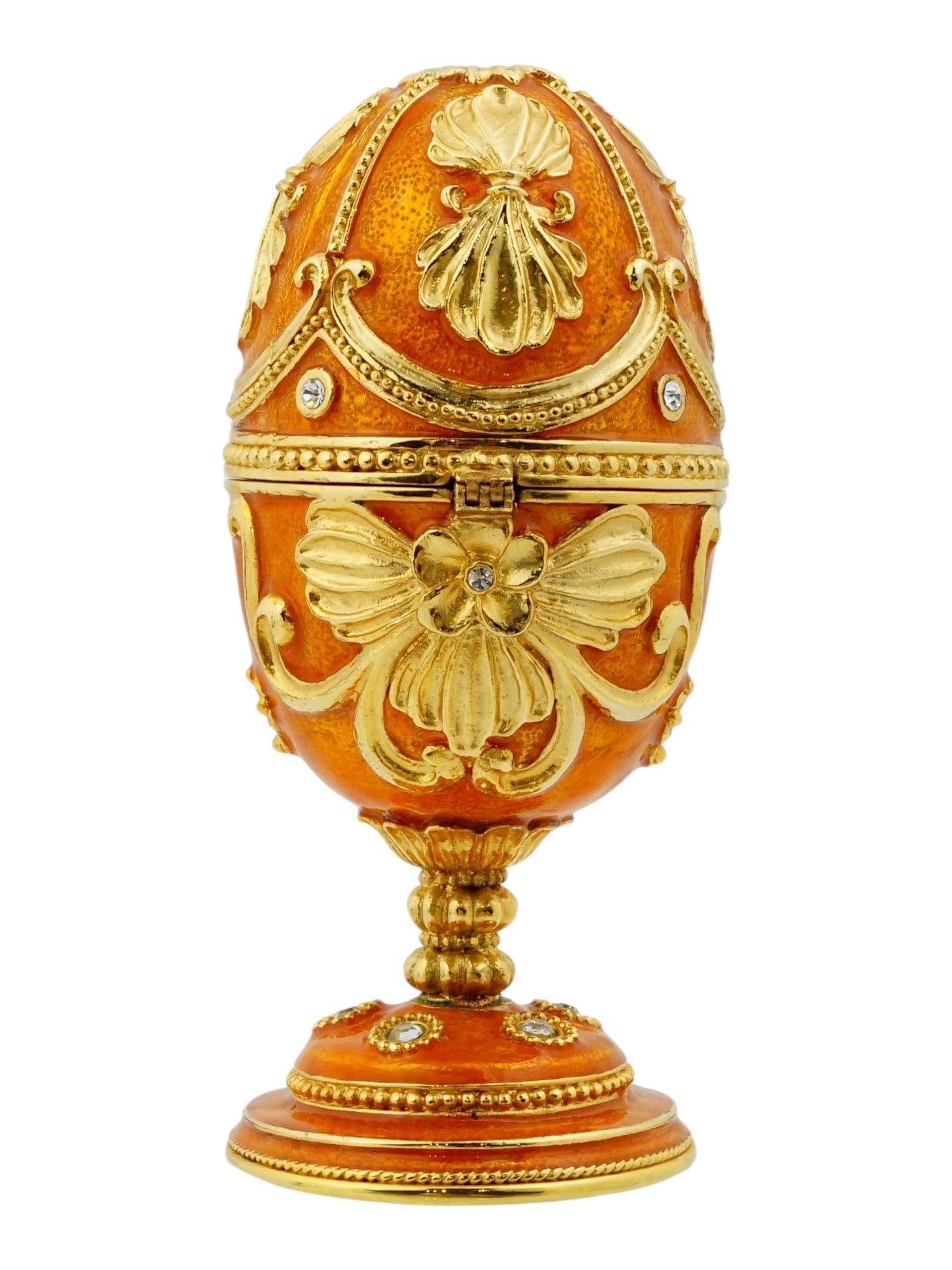 RUSSIAN ENAMEL EASTER EGG TRINKET BOX W HINGED OPENING: A Russian enameled Easter egg trinket box. The piece features an orange enamel finish with a guilloche texture, accented by ornate gilt scrollwork, floral motifs, and crystal embellishments. Designed