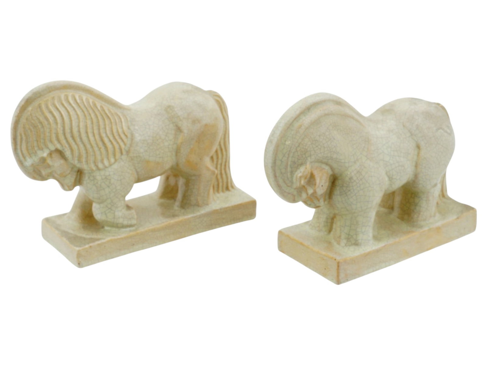 PAIR OF VINTAGE CERAMIC HORSE BOOKENDS IN CHINESE STYLE: A pair of vintage ceramic horse bookends inspired by the equestrian figures of the Chinese Tang Dynasty. The stylized horses stand on rectangular plinth bases and feature an attractive cream-colored c