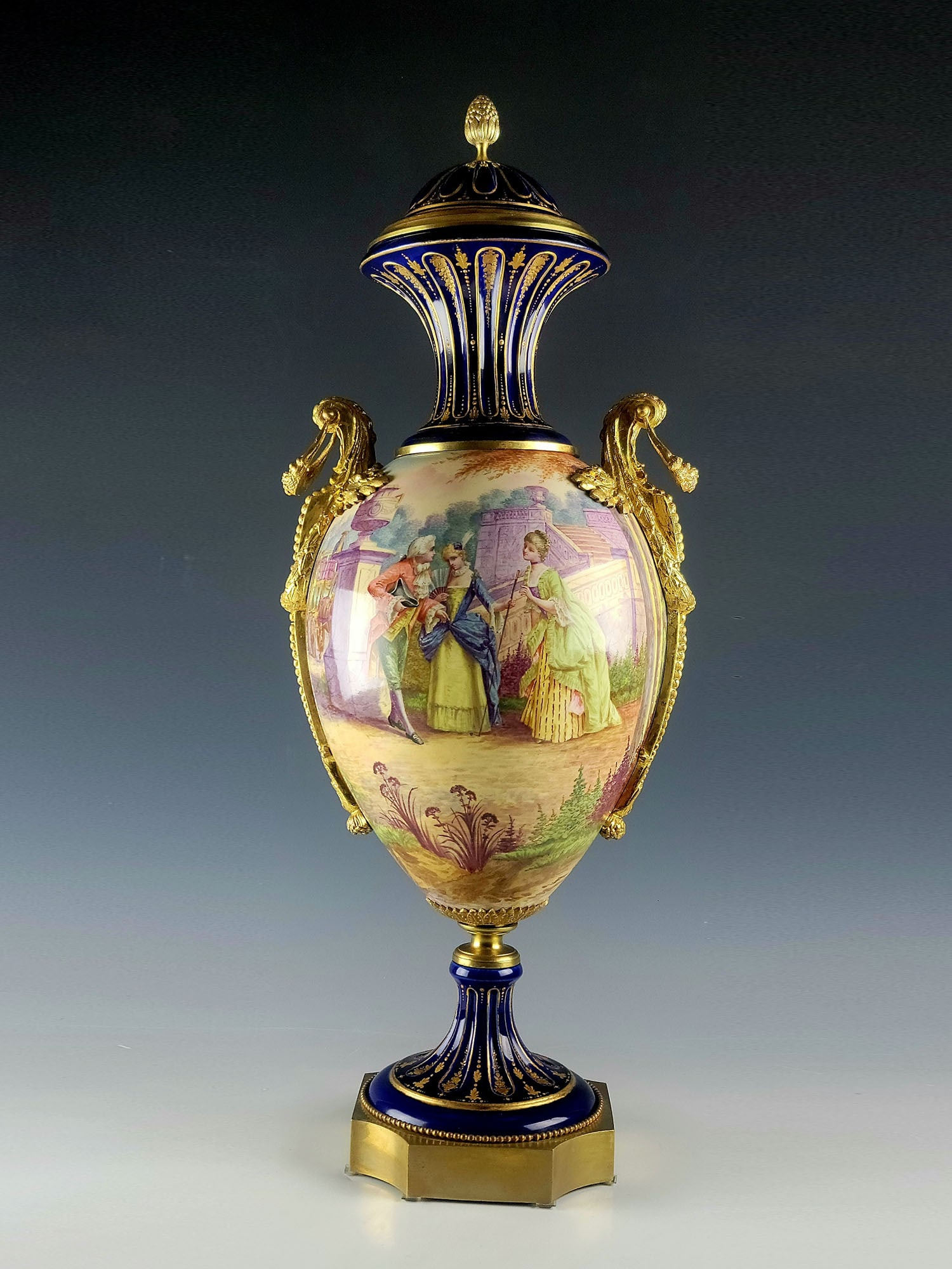 ANTIQUE 19 C FRENCH SEVRES GILT BRONZE PORCELAIN VASE: A gorgeous antique 19th century French Sevres porcelain gilt bronze mounted lidded urn vase. Hand painted all around, the front with a courting couple scene and the back with a landscape. Large beauti