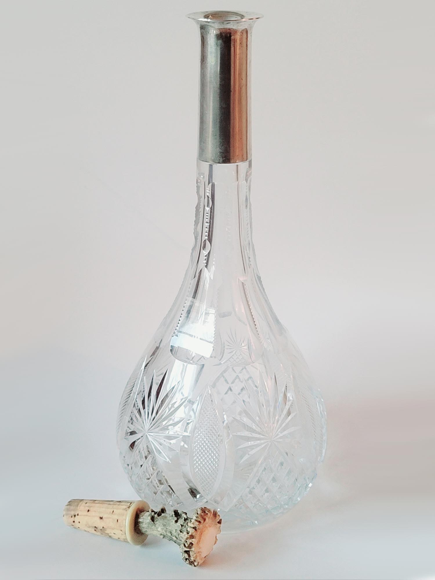 ANTIQUE 19TH C GERMAN CUT CRYSTAL SILVER DECANTER: An antique German cut crystal silver mounted decanter. The body is cut with elaborate fans and diamond patterns. The silver mount is hallmarked with an 800 with crescent moon and crown German silver h