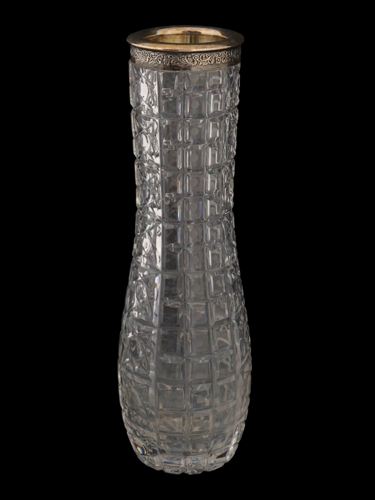RUSSIAN IMPERIAL CUT GLASS VASE W CHASED SILVER MOUNT: A Russian Imperial cut glass vase. The heavy crystal body is decorated with deep geometric cut patterns, while the baluster form reflects traditional Russian design. The chased silver mount, embellish