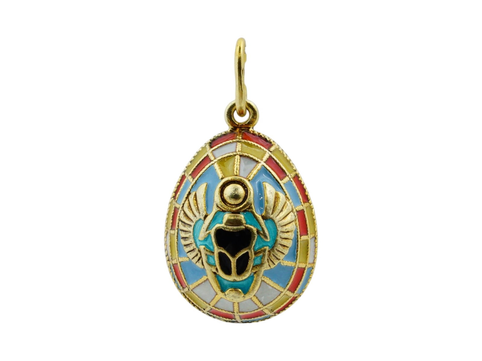 RUSSIAN EGYPTIAN STYLE SILVER ENAMEL EASTER EGG PENDANT: A fine Russian gilt sterling silver and enamel miniature Easter egg pendant. The Egyptian style pendant featuring a raised winged scarab on both sides and divided into sections in yellow, red and blue