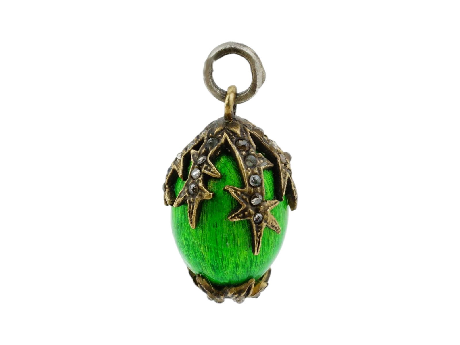 RUSSIAN GILT SILVER GUILLOCHE ENAMEL EGG PENDANT: A fine Russian gilt silver and enamel miniature Easter egg pendant. The surface is covered with a shimmering green guilloche enamel and decorated with a raised motif of stars. Marked on the fitting ri