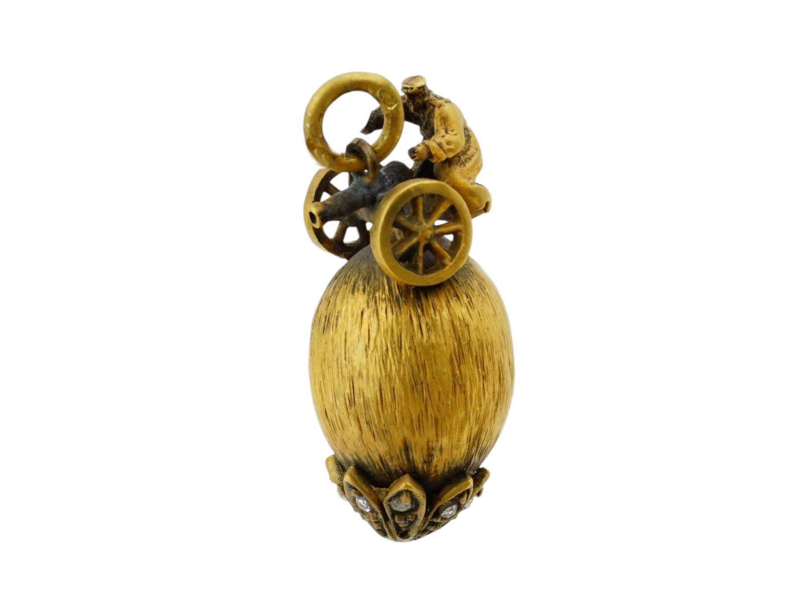RUSSIAN SILVER DIAMOND GOLD YELLOW EASTER EGG PENDANT: A Russian 88 gilt Silver Easter egg pendant. The pendant is crafted in yellow gold and silver, featuring a textured surface and a decorative base. The main body mimics a brushed or textured natural fi