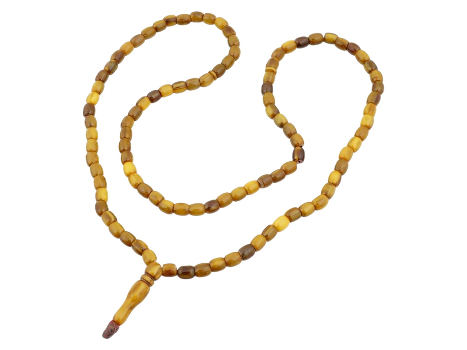 VINTAGE BAKELITE TASBIH ISLAMIC STRAND OF PRAYER BEADS: A strand of prayer beads, known as a tasbih or misbaha, is composed of barrel shaped beads fashioned from phenolic resin, frequently identified as Bakelite. The beads showcase a variegated palette ran