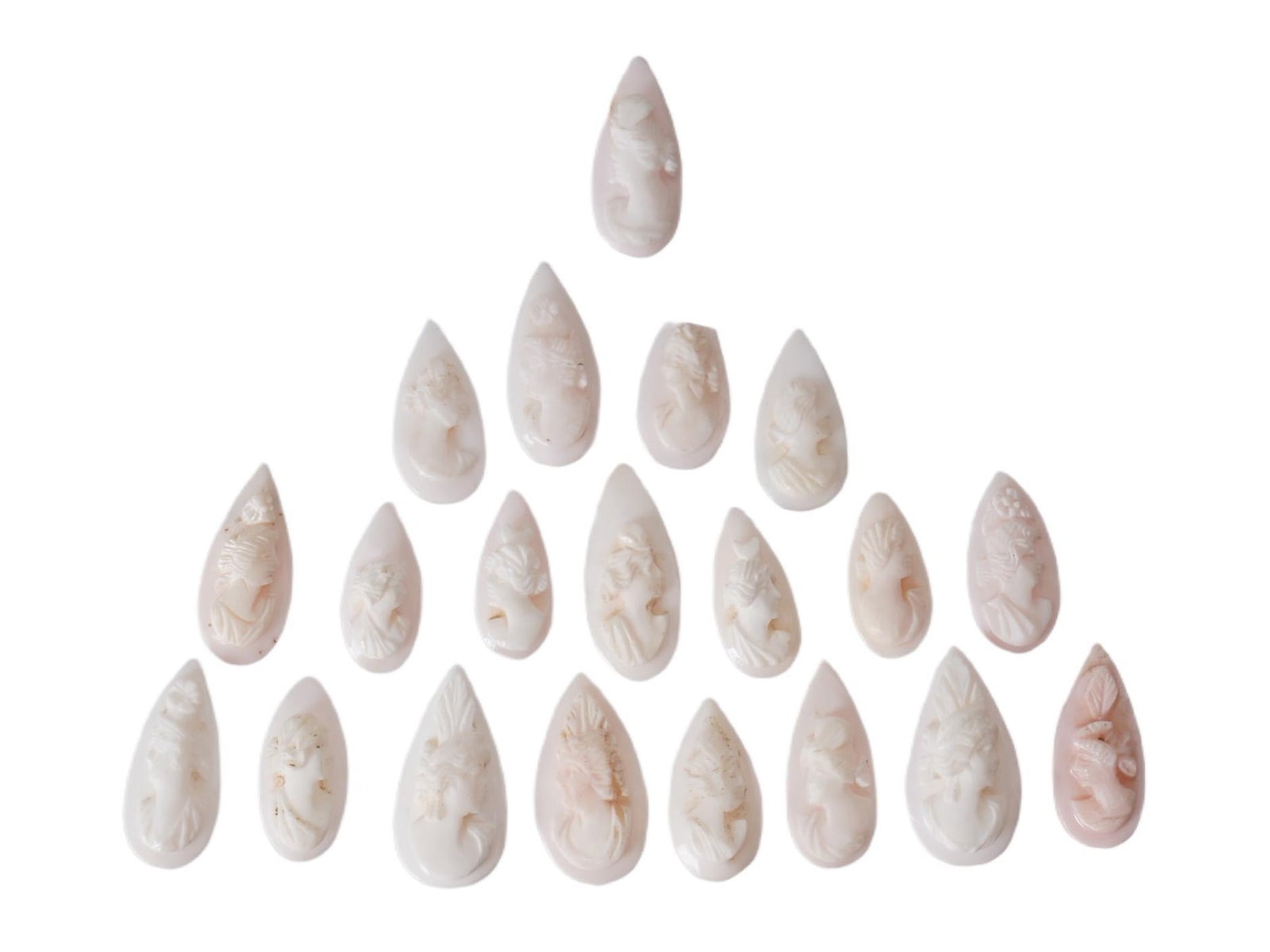 CARVED CORAL CAMEOS WITH FEMALE RELIEF PROFILES: A collection of 20 coral cameos, each featuring a female profile in relief. These carvings are typically made from natural coral, showcasing fine craftsmanship in depicting classical or neoclassical