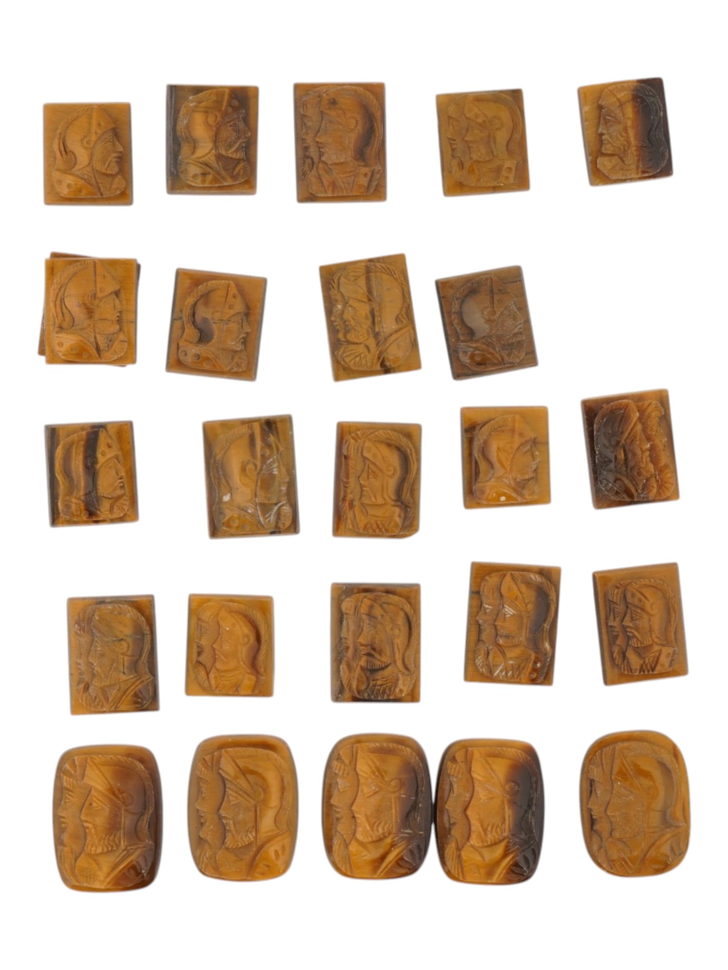 LOT OF WARRIORS PORTRAITS CARVED TIGER EYE CAMEOS: A collection of twenty five vintage cameos in various shapes. Each cameo with a rectangular or oval hand carved Tiger eye panel with relief portrait of a Roman warrior in profile. Vintage Jewelry And