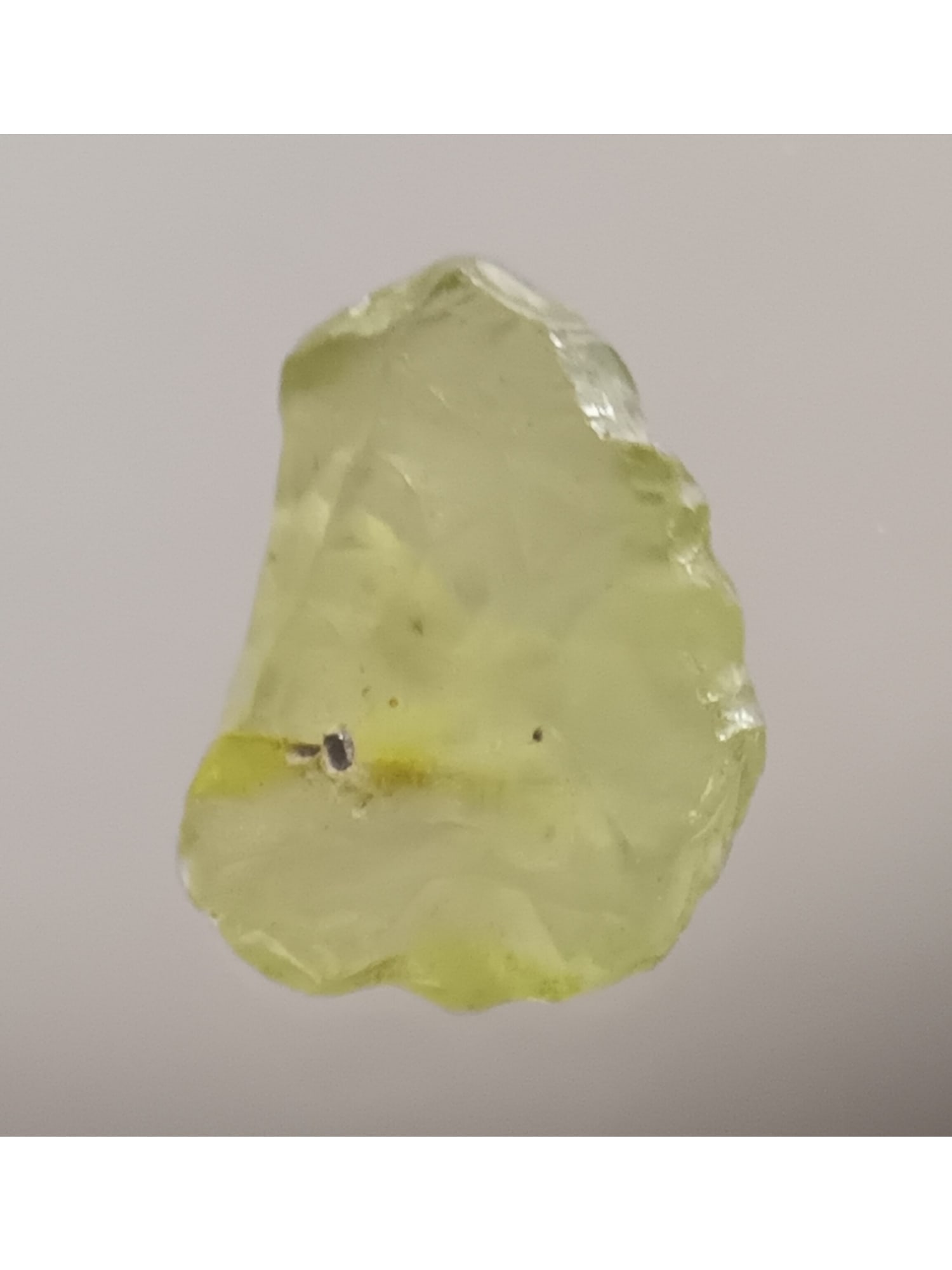 PERIDOT - UNTREATED GEMSTONE: Translucent green peridot with complex crystalline faces (per1/32). Weight: 0.26 grams / 1.3 ct. Origin: Suppat, Kaghan valley, Kohistan, Pakistan. THIS LOT QUALIFIES FOR A 30-DAY UNCONDITIONAL RETURN