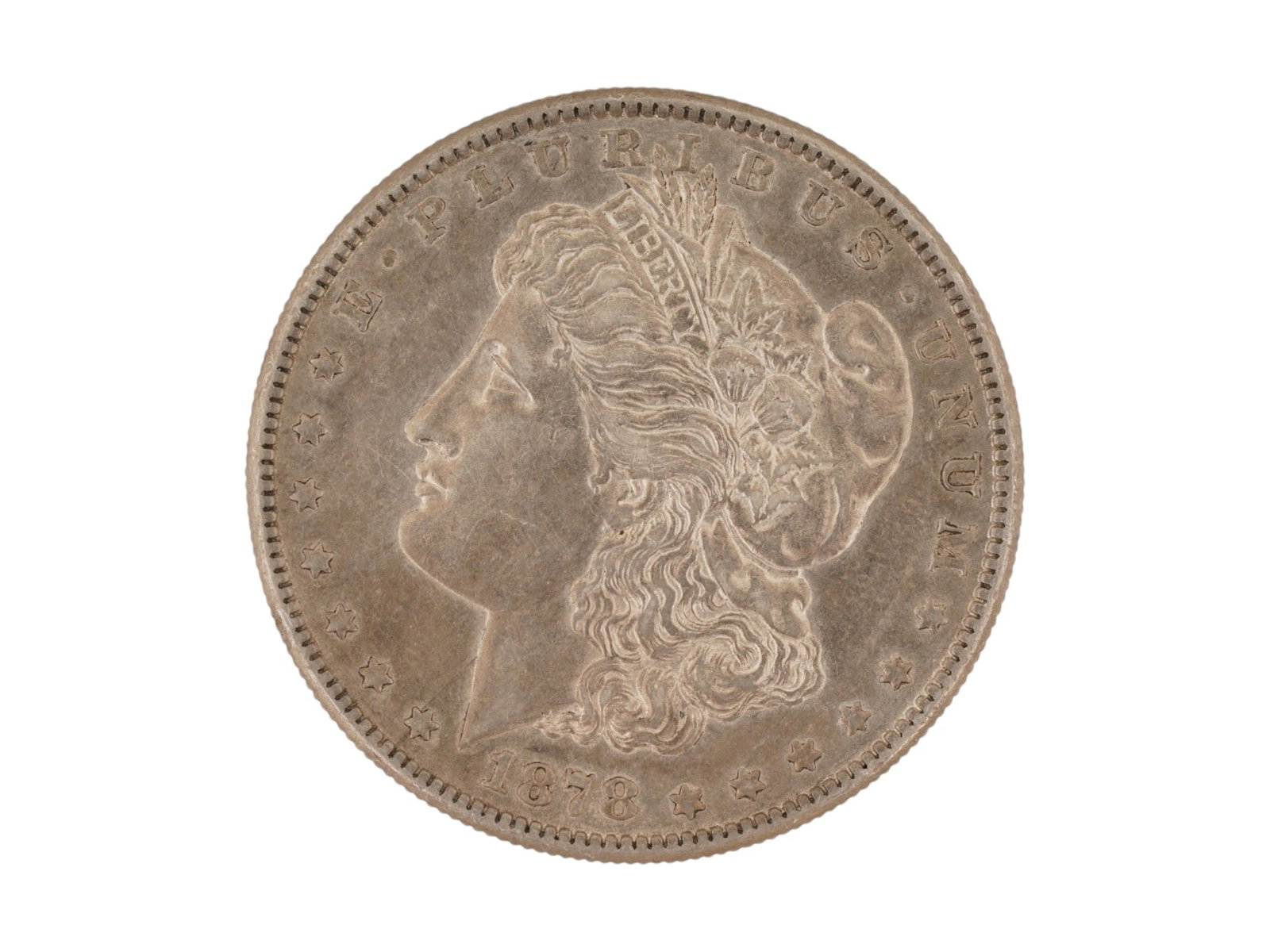 1878 MORGAN SILVER DOLLAR ICONIC AMERICAN SERIES: An 1878 Morgan Silver Dollar, which marked the first year of production for this iconic American series. This classic United States coin features a left facing profile portrait of Lady Liberty. Create