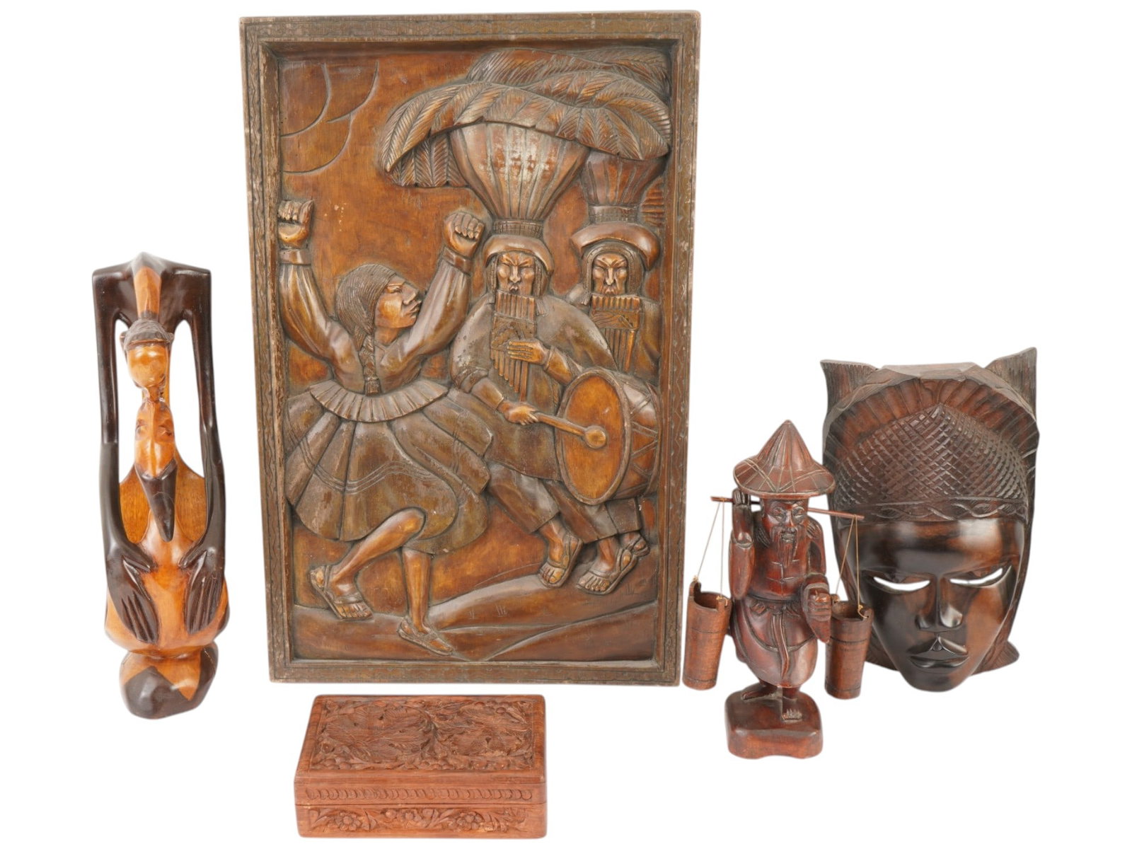 ASSORTED CARVED WOOD PANEL BOX MASK AND FIGURES: A group of assorted carved wood decorative pieces. The lot includes a wooden panel with relief carving depicting a traditional South American dance with musicians. An African carved female mask made o