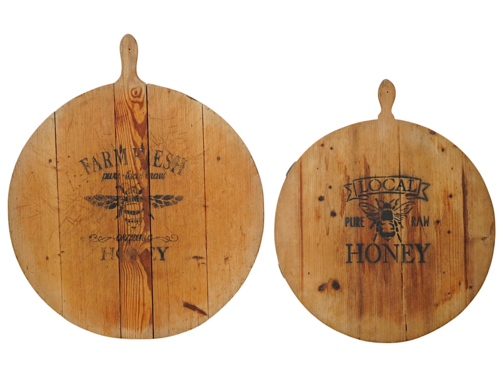 VINTAGE STENCILED WOODEN CUTTING BOARDS: A pair of vintage wooden cutting boards of various size. Round shape with single handles. Both pieces have stencil Raw Honey design. Kitchen Utensils And Accessories, Cooking, Tableware. THIS LOT IS E