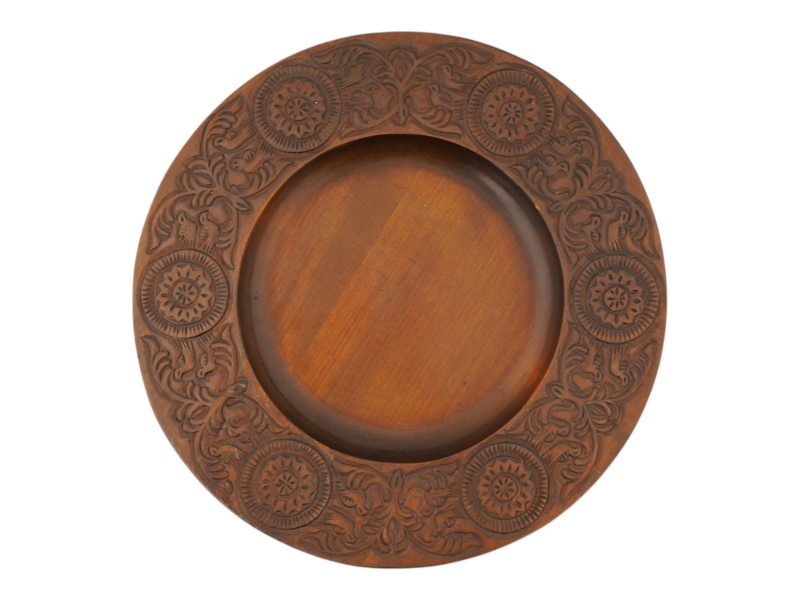 ANTIQUE RUSSIAN HAND CARVED WOODEN BREAD PLATE: An antique Russian wooden bread plate. First half of the 20th century. Solid round piece with hand-carved Abramtsevo-style decoration on the border: solar motif, flowers, and birds. Provenance: Jackso