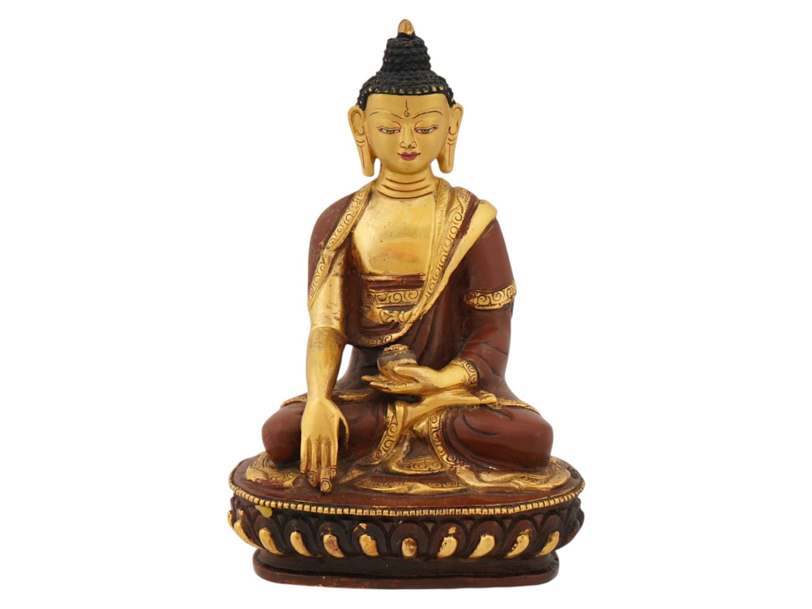 INDIAN PATINATED CARVED FIGURE OF SHAKYAMUNI BUDDHA: An Indian gold patinated and carved wood figure depicting Shakyamuni Buddha seated in dhyanasana atop a stylized lotus pedestal. The sculpture features traditional iconographic elements including a pr