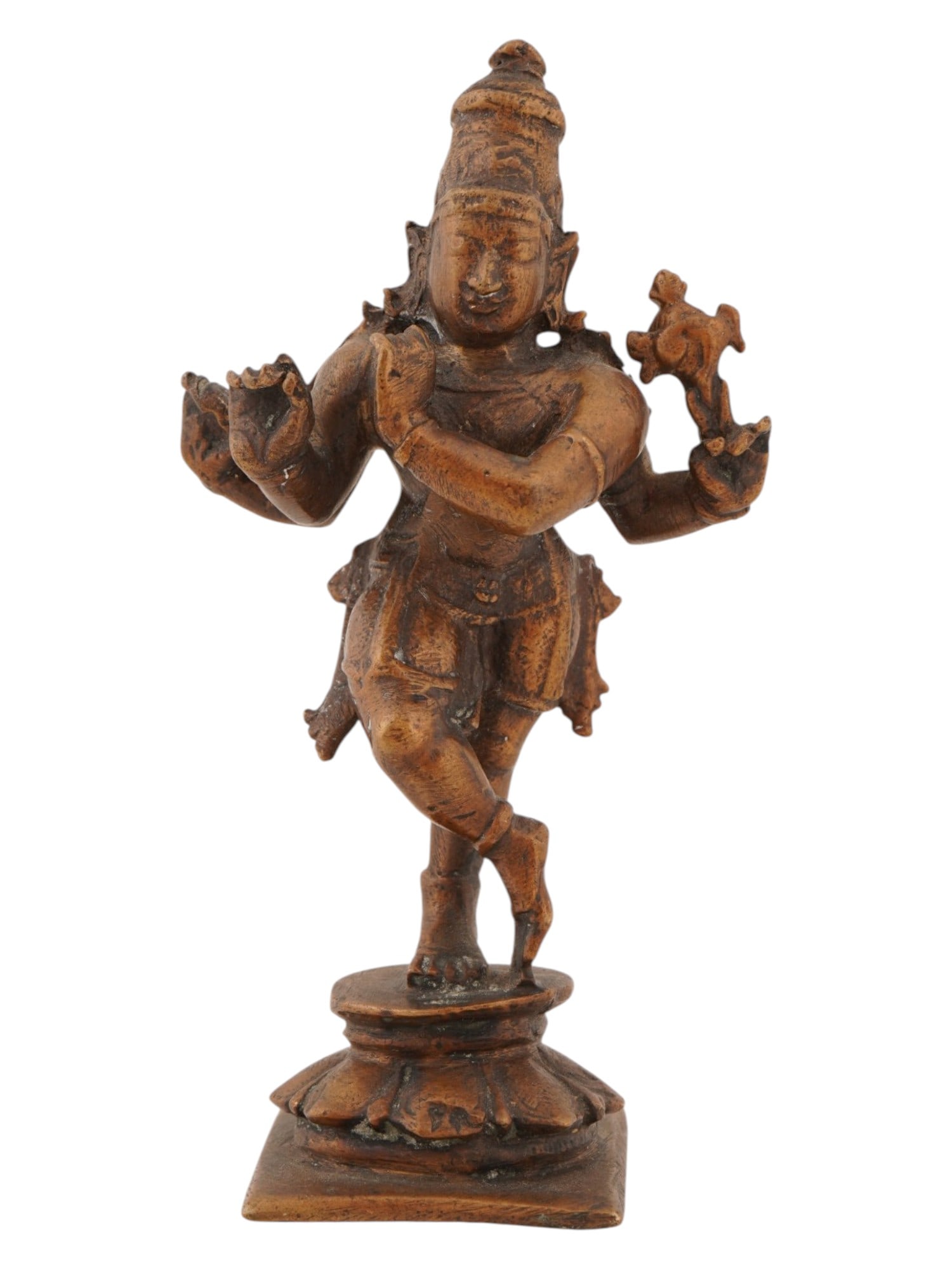INDIAN PATINATED BRONZE FIGURE OF FOUR ARMED KRISHNA: An Indian patinated bronze figure depicting a four armed manifestation of Krishna, standing in a graceful posture with legs crossed at the ankles. The deity is identified by the traditional attributes
