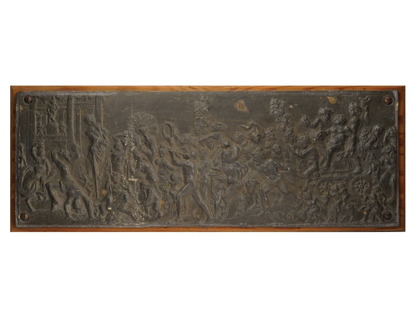 ANTIQUE METAL BACCHANALIAN SCENE BAS RELIEF: An antique horizontally elongated heavy metal, possibly bronze, bas-relief. It depicts a complex multi-figure Bacchanalian scene with numerous mythical figures from antiquity. Mounted on a wooden boar