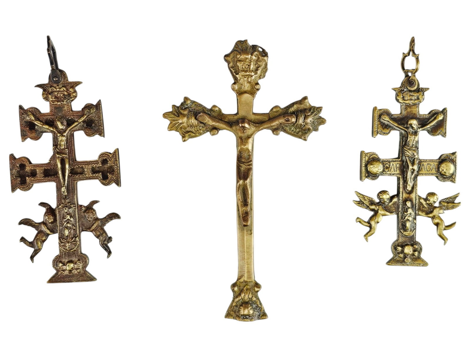 LOT OF ANTIQUE CRUZ DE CARAVACA BRONZE CROSSES: A collection of three antique gold patinated bronze crosses. The collection includes two Spanish Cruz de Caravaca crosses. The crosses are adorned with a characteristic feature, the double crossbar. T