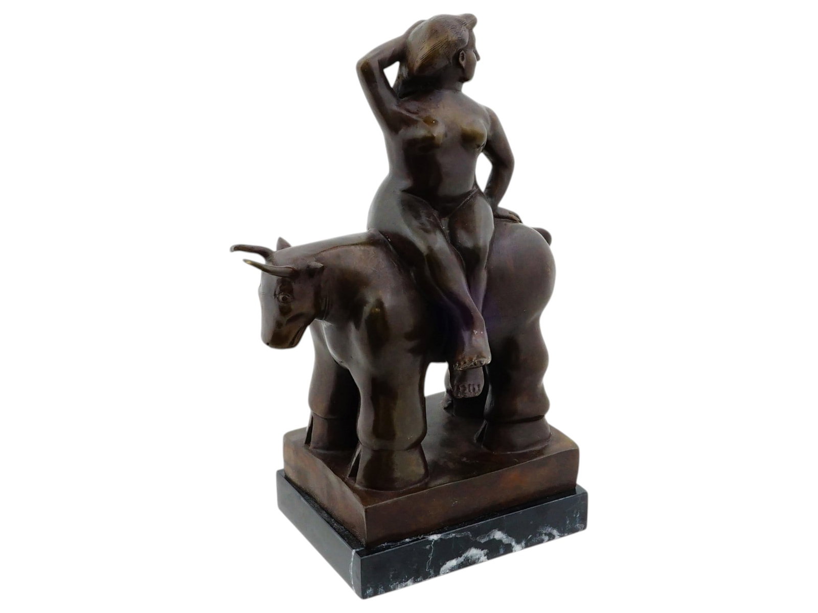 AFTER FERNANDO BOTERO COLUMBIAN BRONZE SCULPTURE: After Fernando Botero, Columbian, 1932 to 2023, cast bronze sculpture. Nude woman riding a bull. Titled Rapto de Europa. Unsigned. The figurine is mounted on a marble base. Fernando Botero was a Colom