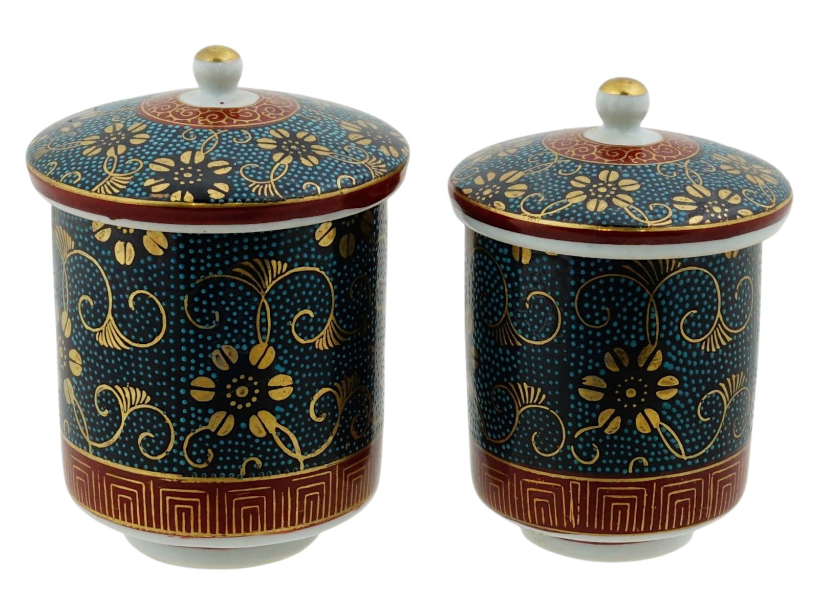 VINTAGE JAPANESE AOCHIBU KUTANI WARE LIDDED TEACUPS: A pair of vintage Japanese Kutani ware lidded teacups decorated in the traditional Aochibu style with fine raised blue-green enamel dot work. The design features elegant clematis blossoms and scrollin