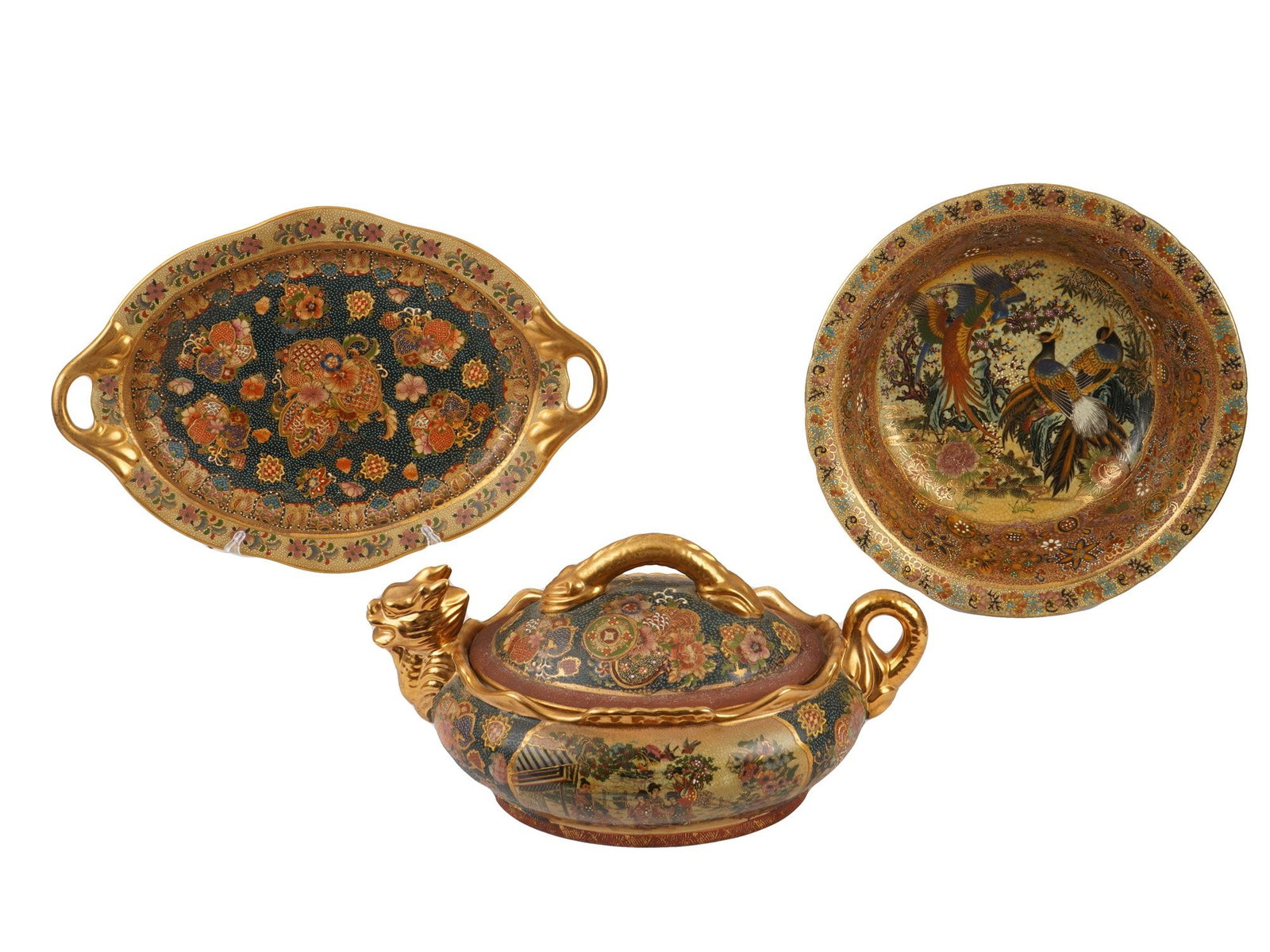 ROYAL SATSUMA STYLE HAND PAINTED PORCELAIN TABLEWARE: A set of Royal Satsuma style hand painted porcelain tableware. The lot includes an oval tray with two handles and a wavy edge, a lidded tureen modeled after golden dragon motifs, and a deep plate with