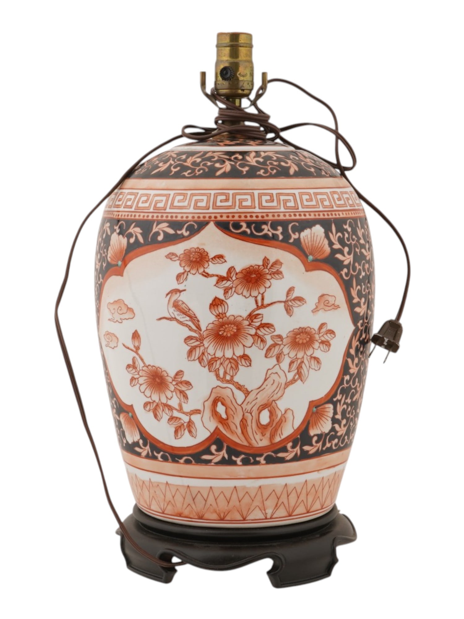 ANTIQUE CHINESE QING HAND PAINTED PORCELAIN VASE LAMP: An antique Chinese porcelain vase converted into a table lamp with electrical fittings. Late Qing dynasty, before 1912. Hand-painted floral patterns in red and black. Mounted on a footed wooden base. 
