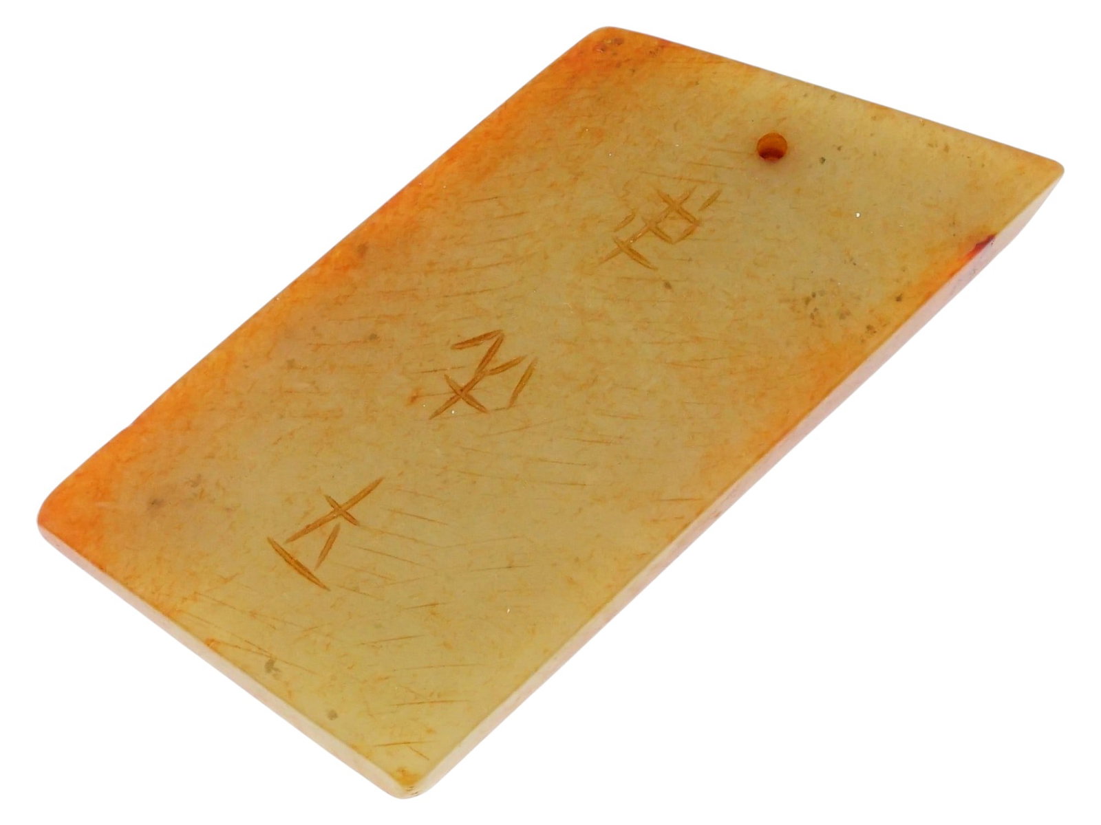 CHINESE ARCHAISTIC RUSSET JADE INSCRIBED AXE PLAQUE: A Chinese archaistic jade pendant plaque styled after ancient ritual blades or tablets, featuring a rectangular body with a characteristic asymmetrical, sharply slanted top edge. The piece is fashione
