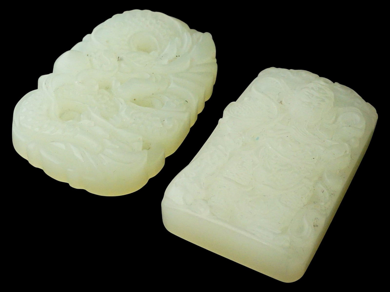 PAIR OF CHINESE HETIAN JADE PENDANT PLAQUES: A pair of Chinese hand-carved Hetian jade pendants. Rectangular format, one has figurative rims. Bas-relief dragon and male character motifs. Collectible Oriental Asian Gemstone Jewelry. THIS LOT IS E