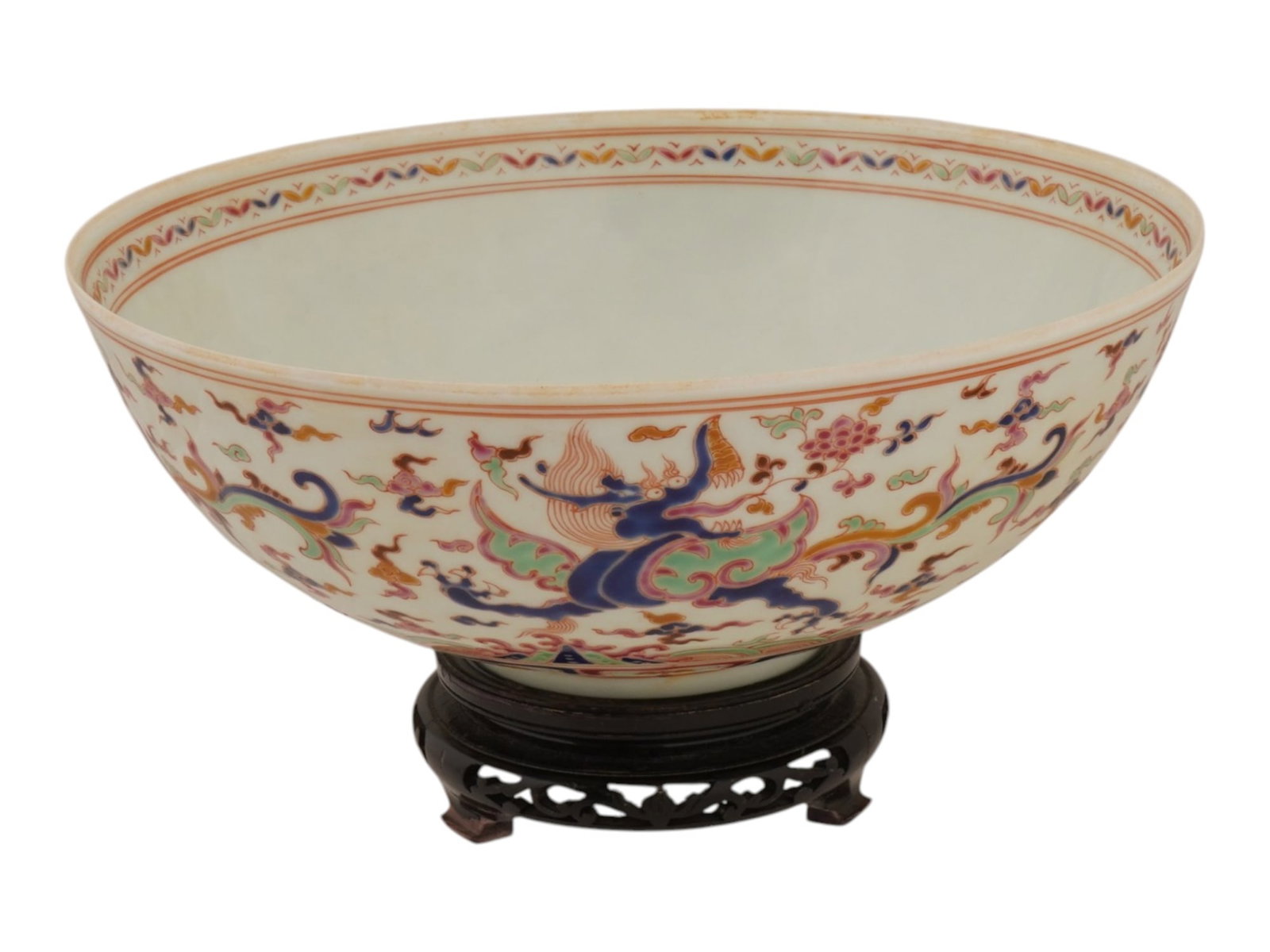 LARGE CHINESE FIVE COLOR DRAGON PATTERN PORCELAIN BOWL: A large Chinese porcelain bowl featuring a five color pattern. The bowl is decorated in the wucai palette, featuring a central interior medallion and an exterior frieze of multiple dragons chasing fla