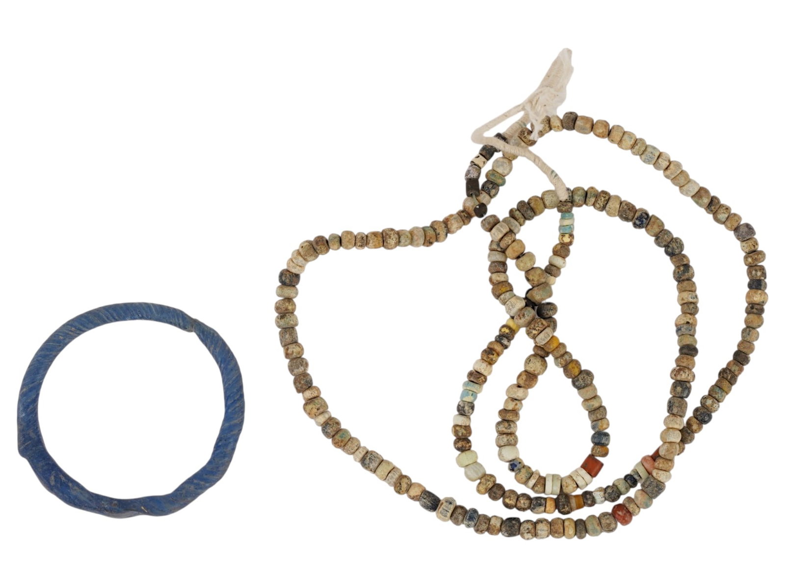ANCIENT ROMAN EMPIRE GLASS BRACELET AND BEADED NECKLACE: A pair of Ancient Roman glass jewelry. Imperial Rome era, ca. 100 to 300 AD. Multicolor glass beaded necklace on a string. Twisted blue glass bangle bracelet. Historical Finds And Archaeological Relic