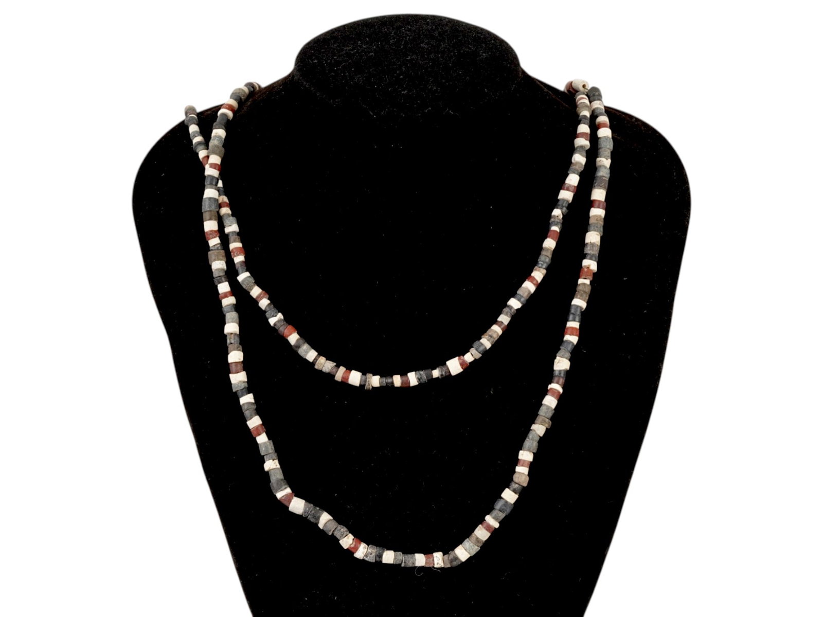 TWO ANCIENT EGYPTIAN STEATITE MULTICOLOR NECKLACES: A group of two ancient Egyptian carved steatite stone necklaces. CIrca Late Period, 700 to 200 BC. The necklaces are approximately the same length and consist of small tubular beads of alternating col