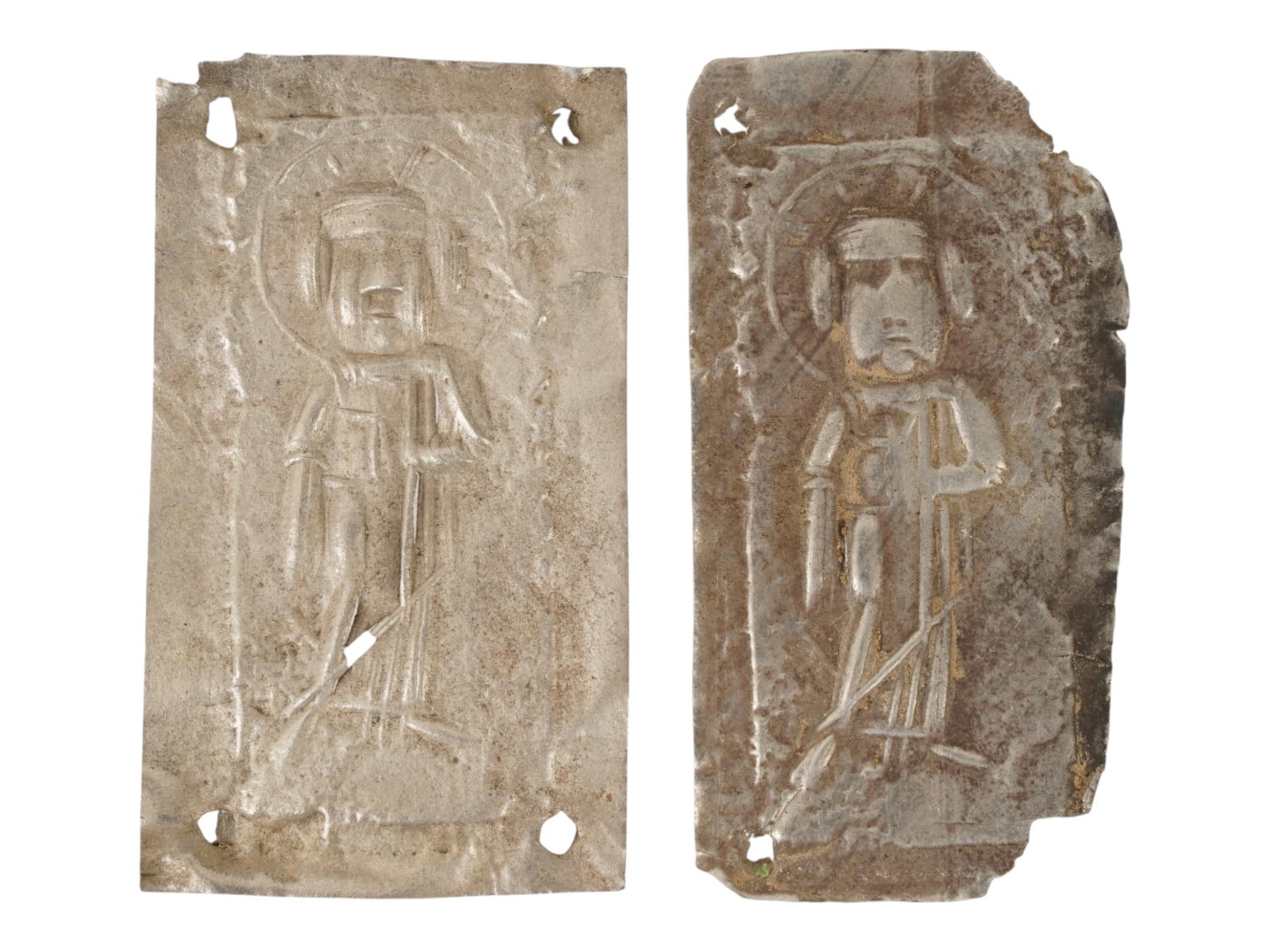 GROUP OF TWO ANCIENT BYZANTINE SILVER VOTIVE PLAQUES: A group of two ancient Byzantine silver votive plaques dating circa 400 to 600 AD, each depicting the figure of Jesus in early Christian iconographic style. These devotional objects were likely offere