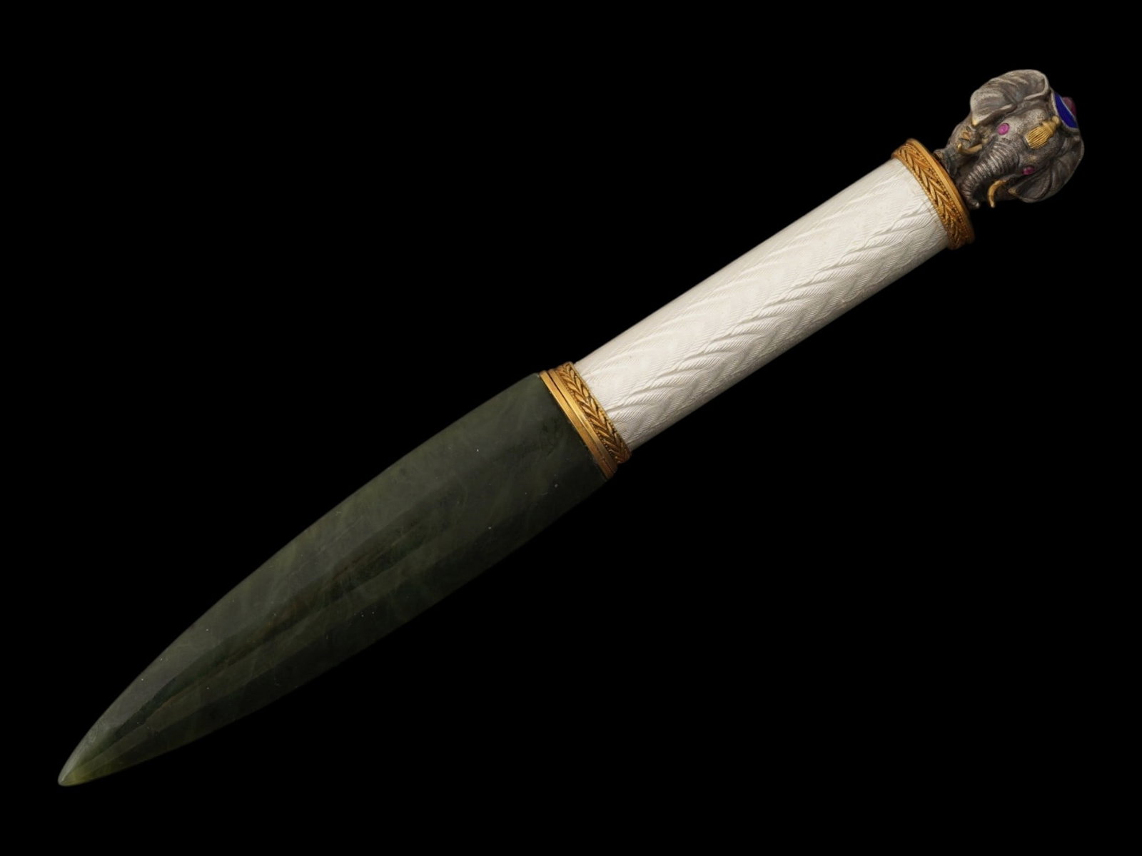 RUSSIAN SILVER ENAMEL NEPHRITE RUBY LETTER OPENER: A Russian Neoclassical gilt silver paper knife or letter opener in the style of a Roman gladius sword. Nephrite jade blade. The handle is decorated with white guilloche enamel. Enameled elephant finia