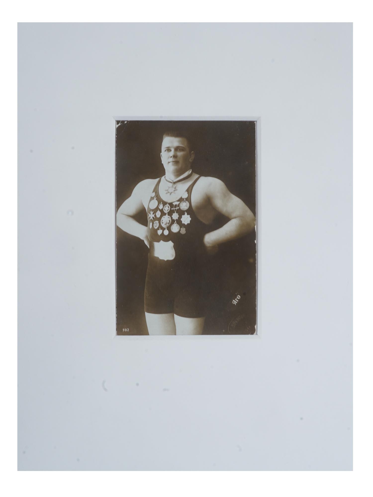 ANTIQUE RUSSIAN PORTRAIT PHOTO OF ESTONIAN WRESTLER: An antique Russian post card with a black and white photograph, depicting a studio portrait of Jaan Jaago, a famous wrestler. 1913 to 1915, 1924 to 1926 and 1928 he won three times World Wrestling Cha