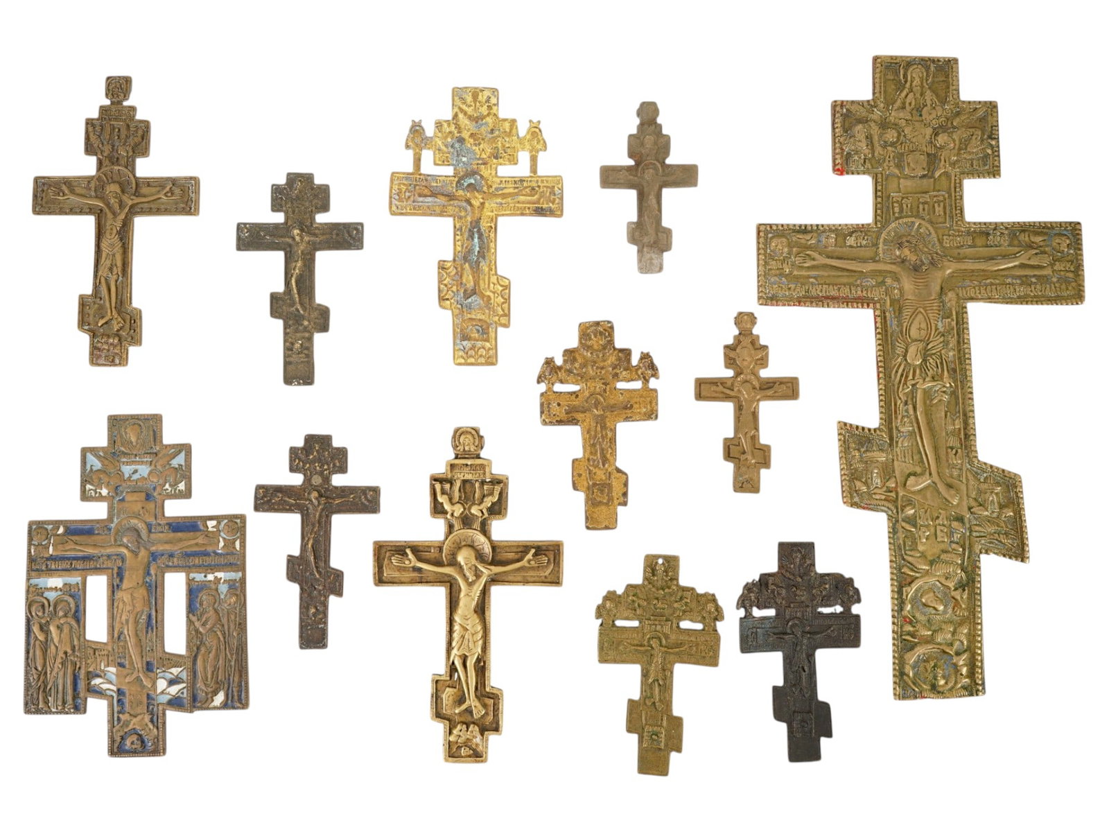 LOT OF ANTIQUE RUSSIAN ORTHODOX CAST BRONZE CROSSES: A lot of twelve antique 19th-century Russian Orthodox cast bronze crucifix crosses of various size. One piece is decorated with enamel. Collectible Russian Icons, Antiques, Christian Religious Art, Me