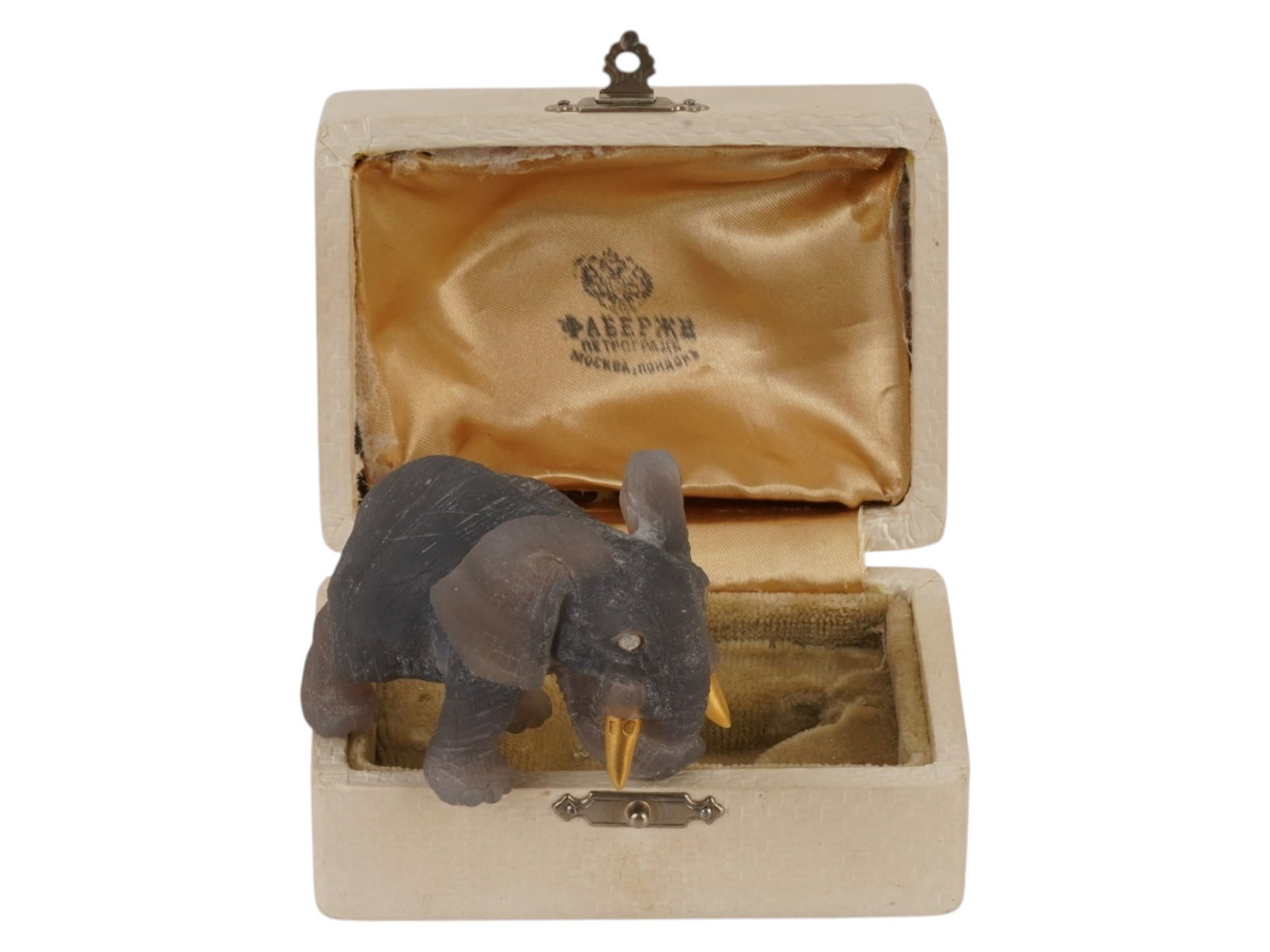 RUSSIAN AGATE ELEPHANT FIGURE GOLD TUSKS SILVER DIAMOND: A Russian carved Agate figurine depicting an elephant in a walking pose. The animal is set with two rose cut diamond eyes in gilt silver collets and features a pair of tapering gold tusks, which bear