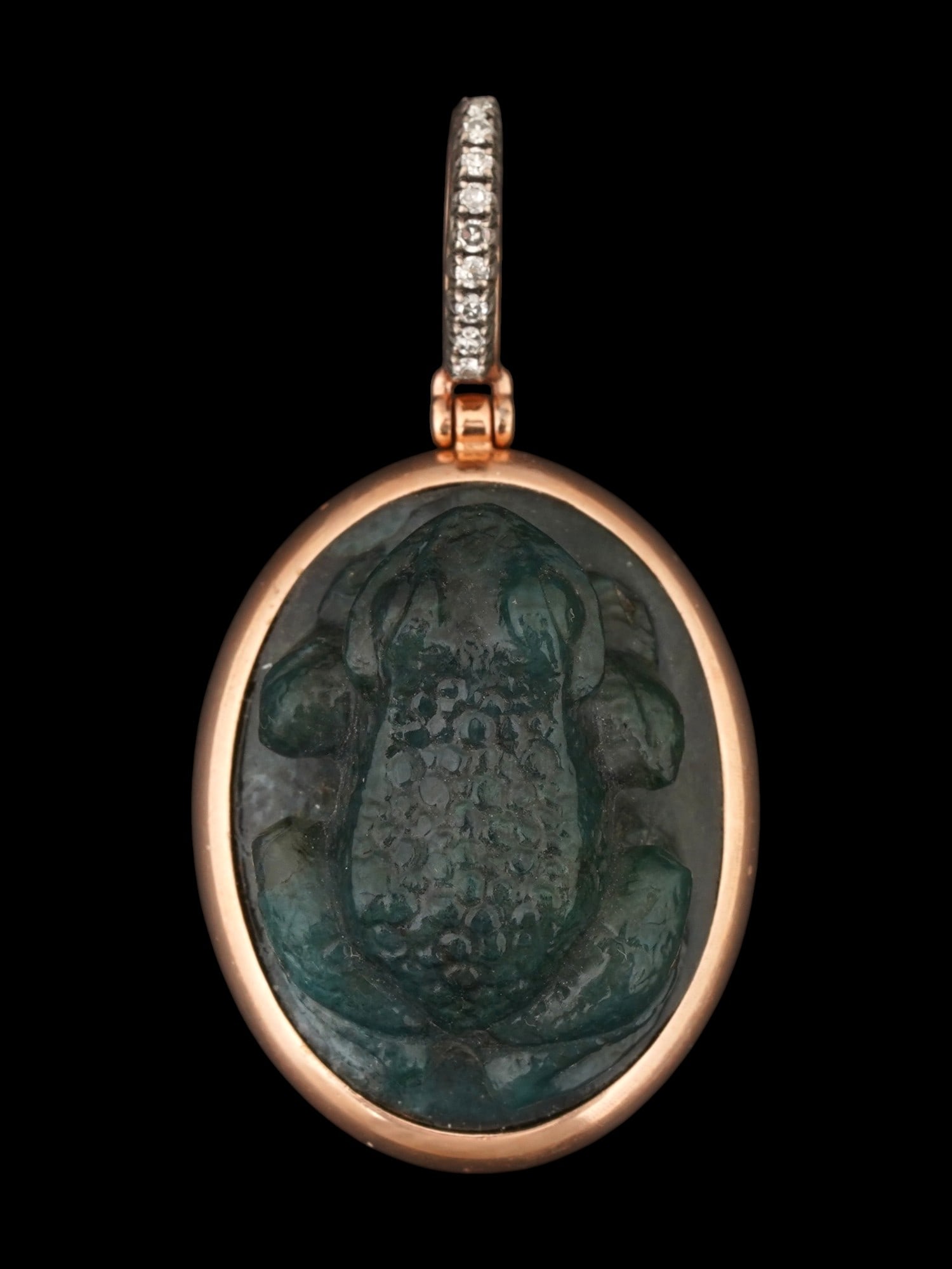 RUSSIAN GOLD AND CARVED JADE FROG PENDANT W DIAMONDS: A Russian gold and hand carved jade frog pendant. The articulated bail is channel-set with a row of small round-cut diamonds, providing a brilliant contrast to the dark hardstone figure. The rim of th