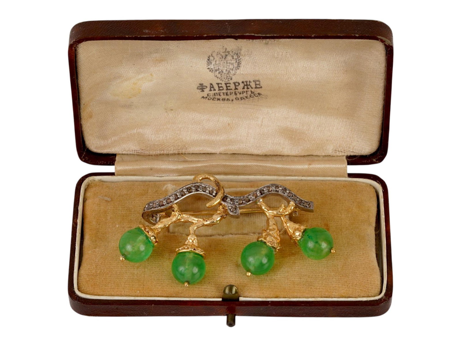RUSSIAN GOLD SILVER EMERALD DIAMOND BERRY BROOCH: A Russian gold and silver pin brooch representing a gooseberry branch. The piece is garnished with emerald beads and diamonds. Hallmark of 56 gold standard and makers mark are on the pin. Total Weight