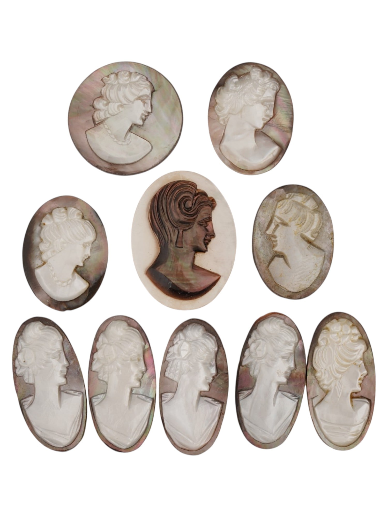 COLLECTION OF FEMALE PORTRAIT CARVED SHELL CAMEOS: A collection of ten hand carved cameo medallions. Each piece is crafted from a conch shell and depicts female portraits in the Victorian manner rendered in high relief. The cameos are presented in ova