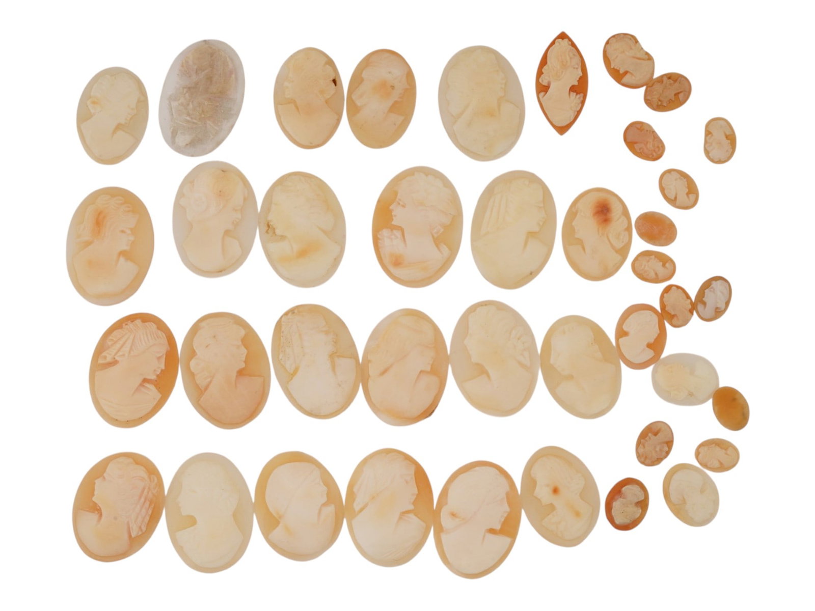 COLLECTION OF VINTAGE CARNELIAN SHELL PORTRAIT CAMEOS: A collection of vintage carnelian shell cameo portrait carvings. The hand-carved cameos depict classical female profile portraits in a variety of sizes suitable for brooches, earrings, pendants, rings