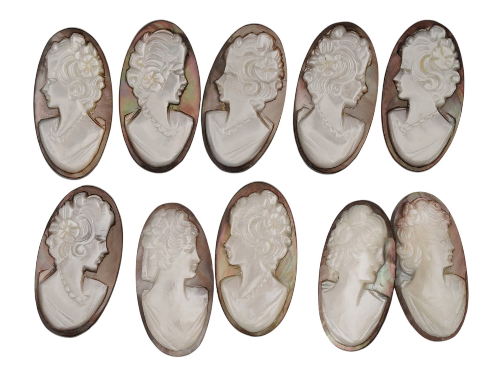 COLLECTION OF FEMALE PORTRAIT CARVED SHELL CAMEOS: A collection of hand carved conch shell cameos. A total of 10 items. Each piece depicts a female profile portrait rendered in high relief. Oval shape. Collectible Jewelry And Glyptic Art, Sculpture. T