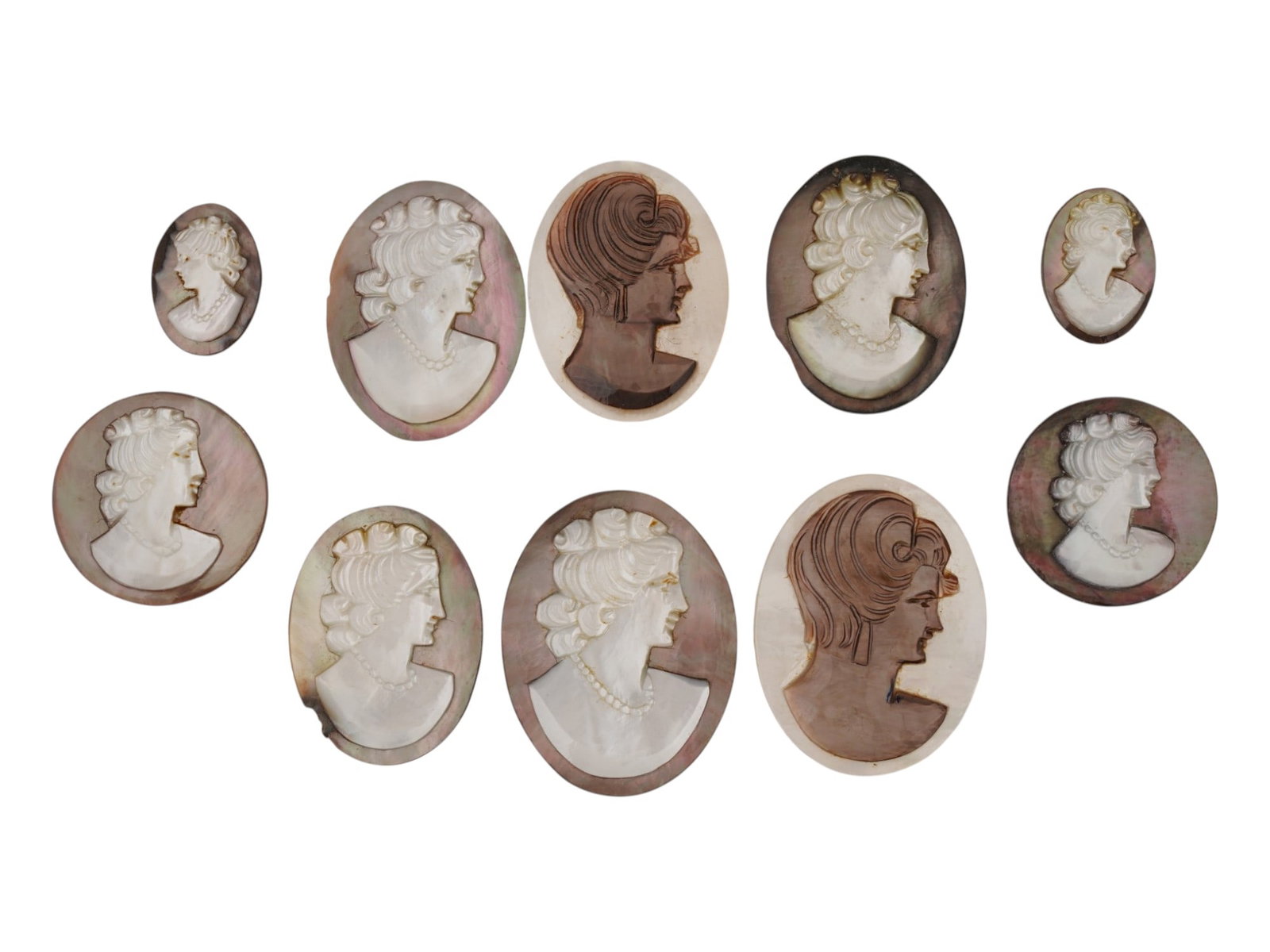 COLLECTION OF FEMALE PORTRAIT CARVED SHELL CAMEOS: A collection of hand carved conch shell cameos. A total of 10 items. Each piece depicts a female profile portrait rendered in high relief. Oval shape. Collectible Jewelry And Glyptic Art, Sculpture. T