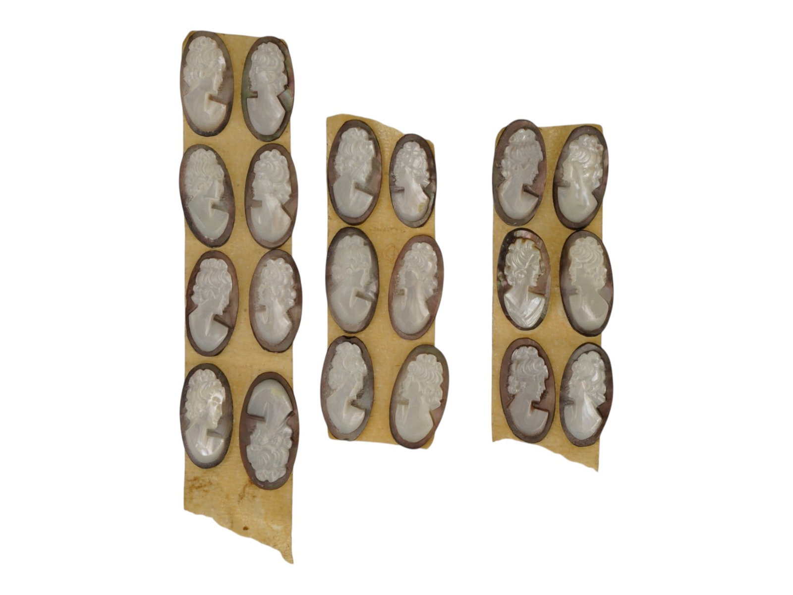 LOT OF CARVED FEMALE PORTRAIT SHELL CAMEO MEDALLIONS: A collection of twenty hand carved shell cameo medallions. The pieces depict a female profile portrait rendered in high relief in the Victorian and Roman manners. Each cameo is fashioned in a distinct